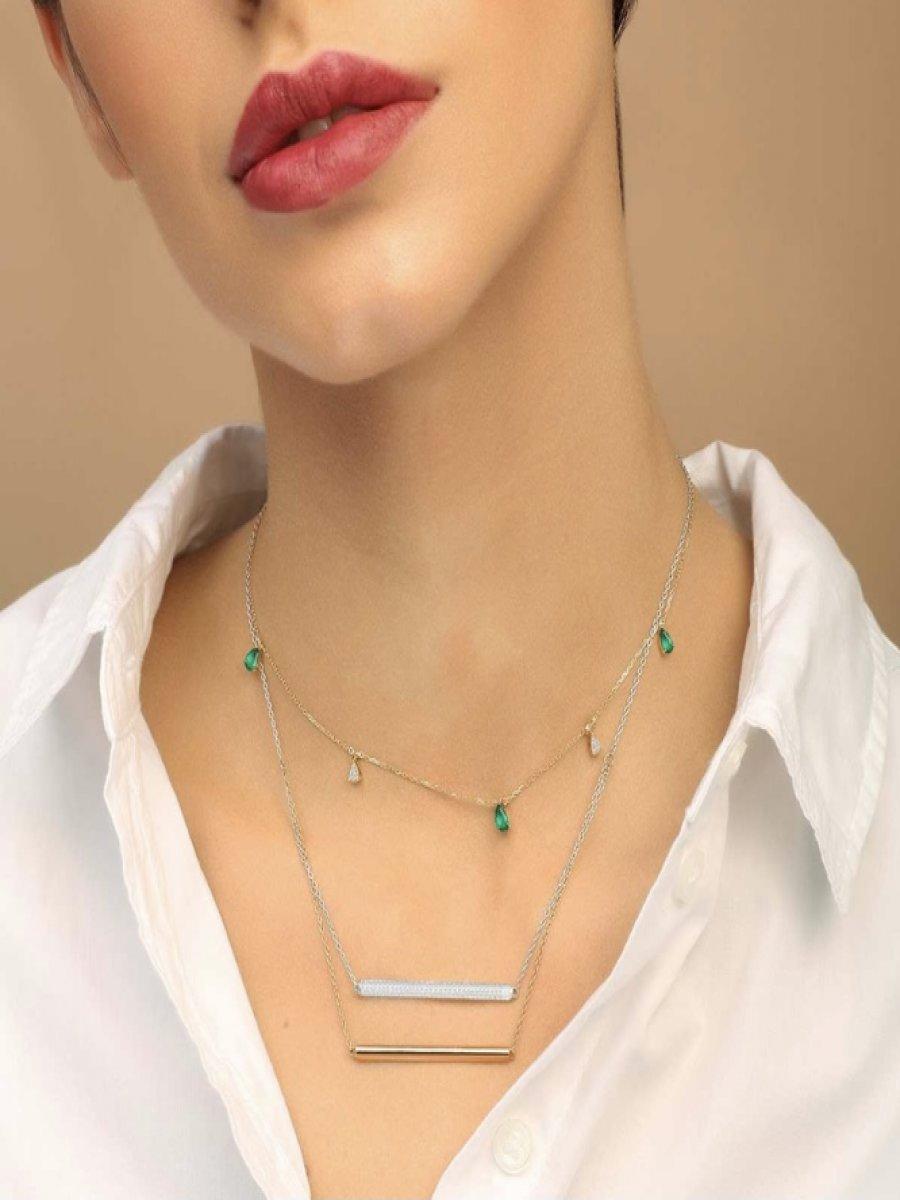 Trendy and versatile; this piece is handcrafted in 18K Solid Gold and set with green Green Tsavorite and scintillating ethnically-sourced White Diamonds. It features an innovative adjustable chain mechanic, allowing you to style or layer as you
