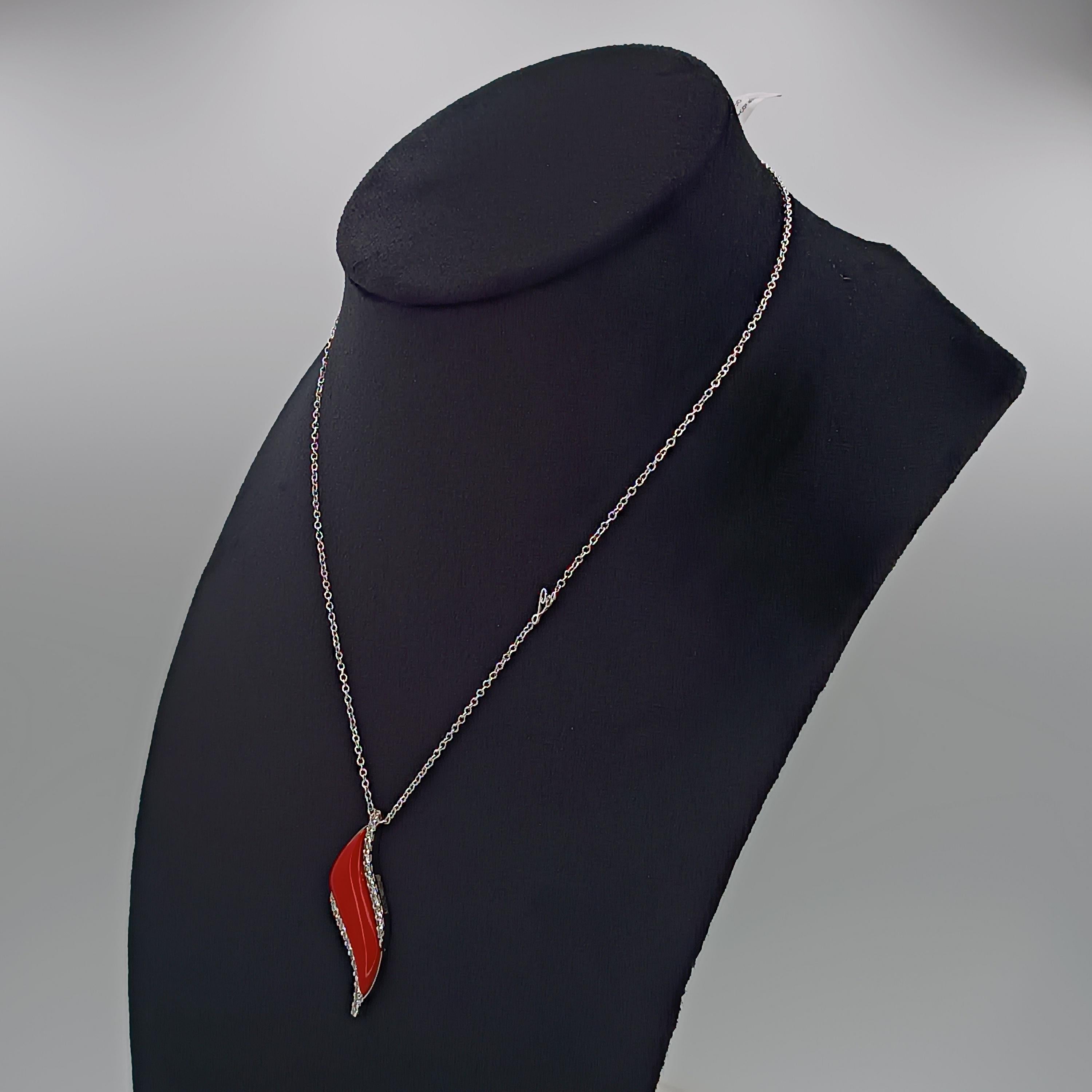 This wonderful Leo Milano pendant from our Conchetta  collection shows in every detail a very complicate yet perfectly done workmanship. The pendant and the chain are in 18 white gold with coral paste . The object weights 8 grams the total diamonds 