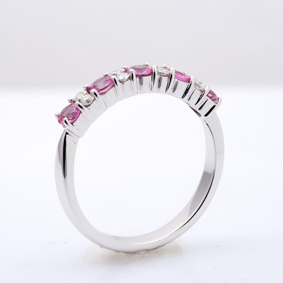 Natural Pink Sapphire 0.72cts/ Diamonds 0.18cts Ring
Luminous 0.72cts pink sapphires are surrounded by 0.18cts diamonds. The ring is set in 14KWG. A distinct style with alternating stacked diamonds between the glowing pink sapphires makes this band