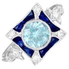 Bague de fiançailles aigue-marine taille ronde de 0.72 carat, halo de saphirs, platine