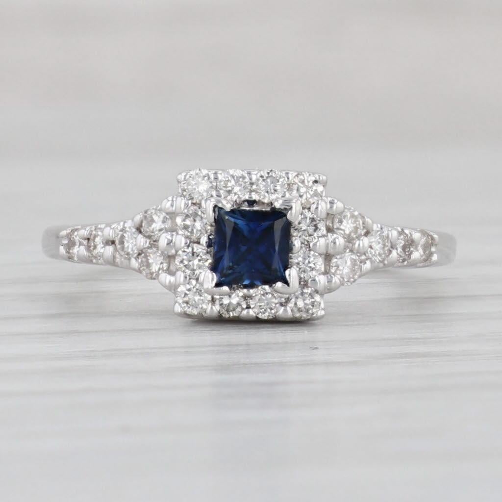 Gemstone Information:
- Natural Sapphire -
Carats - 0.32ct 
Cut - Princess Brilliant
Color - Dark Blue
Treatment - Heated

- Natural Diamonds -
Total Carats - 0.40ctw
Cut - Round Brilliant
Color - H - I
Clarity - SI1 - SI2

Metal: 14k White