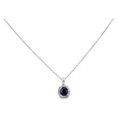 0.73 Carat Blue Sapphire and Diamond Halo Pendant Necklace