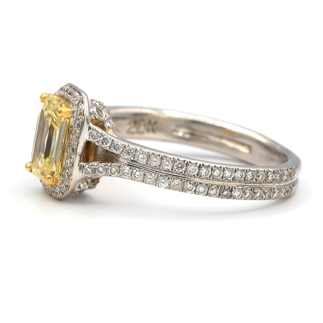 This 0.73 carat Fancy Yellow Emerald shaped diamond, surrounded by 0.45 carat pave white diamonds.
Mounted in 18K/22K White Gold/Yellow Gold
 
ring size 5.5