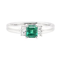 0.73 Carat Natural Emerald and Diamond Ring Set in Platinum