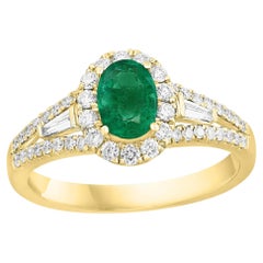 0.73 Carat Oval Cut Emerald and Diamond Ring in 18k Yellow Gold