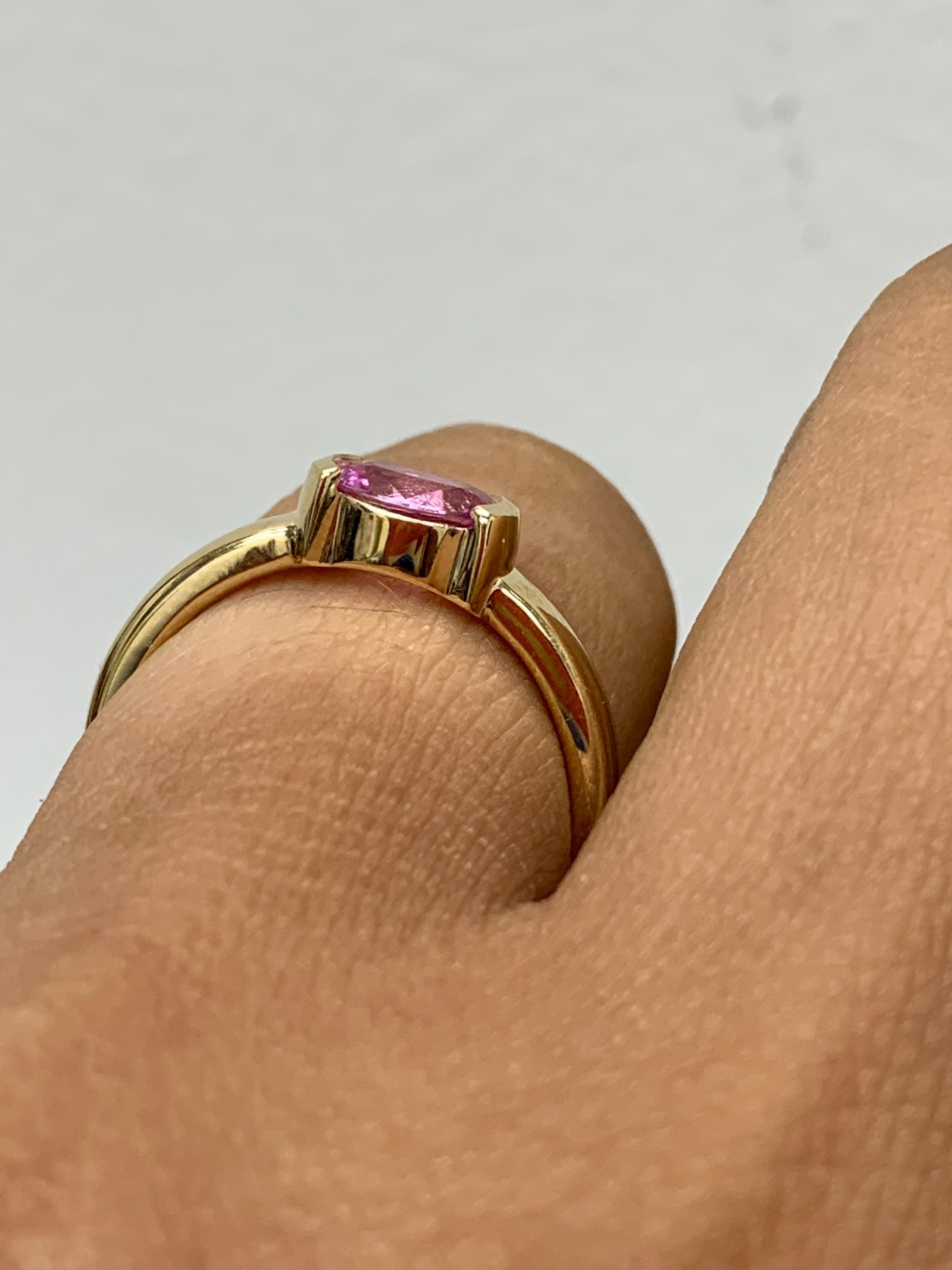 An elegant wedding band ring featuring an astonishing 0.73-carat oval cut pink sapphire, set in a beautiful wide 14K yellow gold band. 

Style is available in different price ranges. Prices are based on your selection. Don't hesitate to get in touch