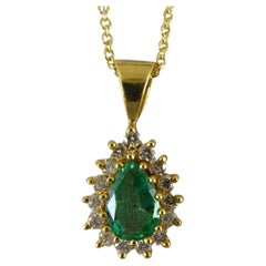 0.73 Carat Pear-Shaped Emerald Pendant in Diamond Surround, Yellow Gold 