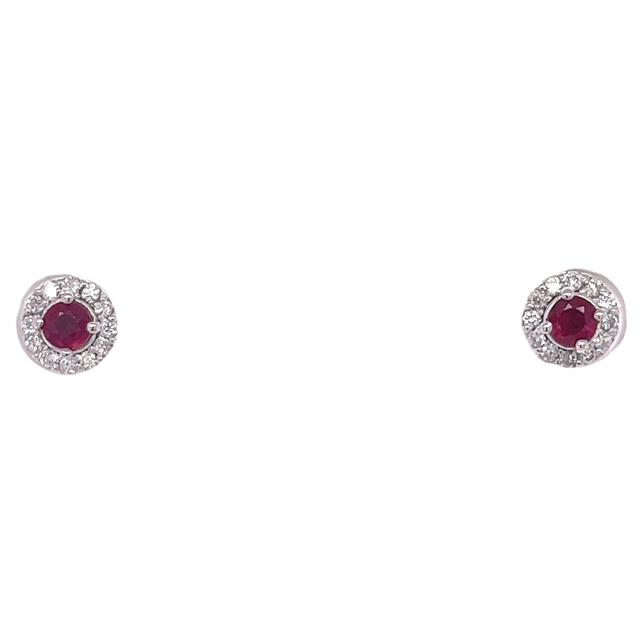 These earrings have 2 Round Cut Natural Rubies that weigh 0.48 carats and have 24 Round Cut Diamonds that weigh 0.25 carats. (Clarity: SI2, Color: F) The total carat weight of the earrings are 0.73 carats.

They are made in 14 Karat White Gold and