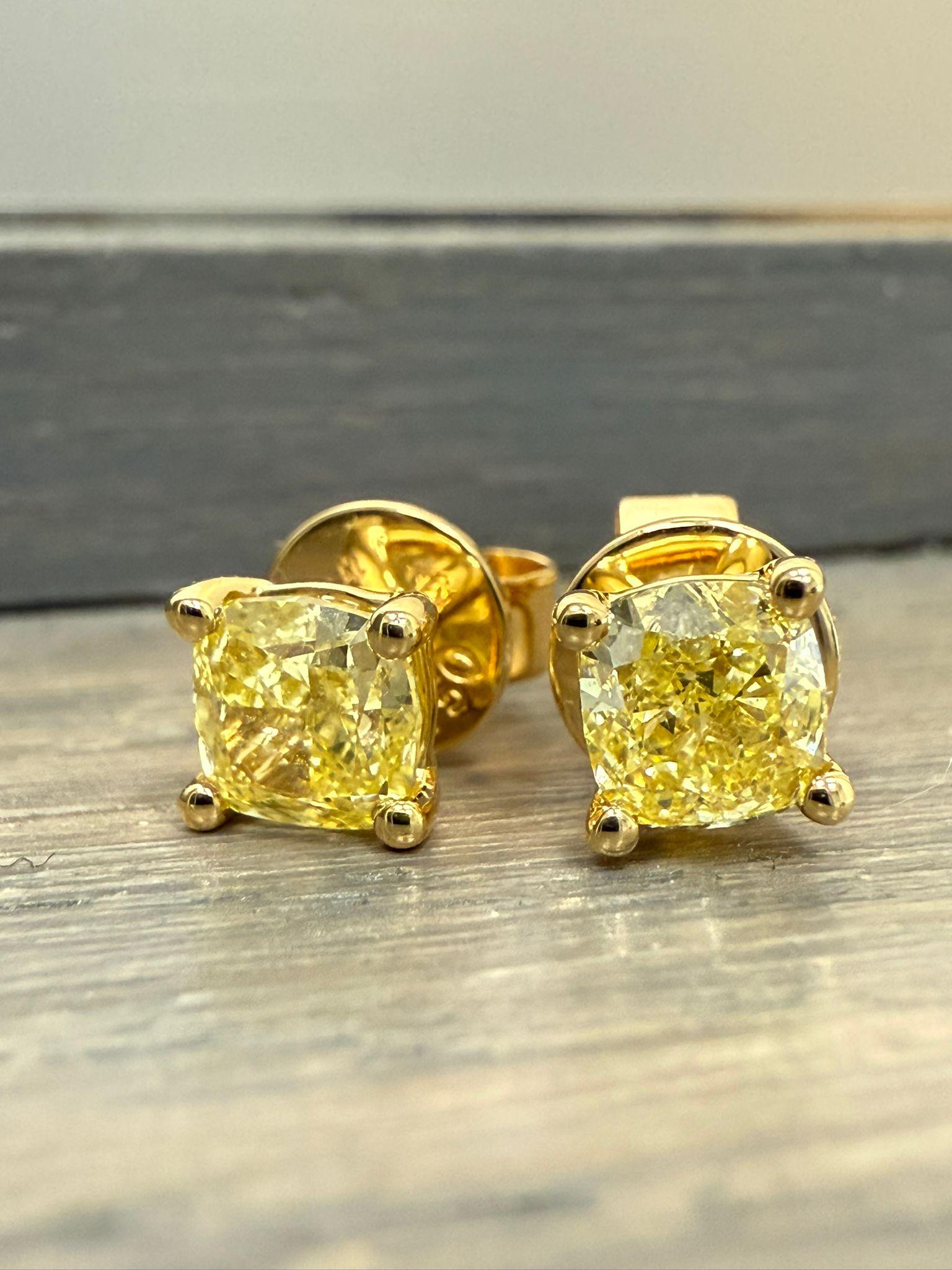 This Fancy Yellow Cushion Cut pair of stud earrings] are a testament to fine craftsmanship and timeless design. Perfect for those who appreciate the beauty of natural diamonds, these earrings offers a balance of luxury and tasteful