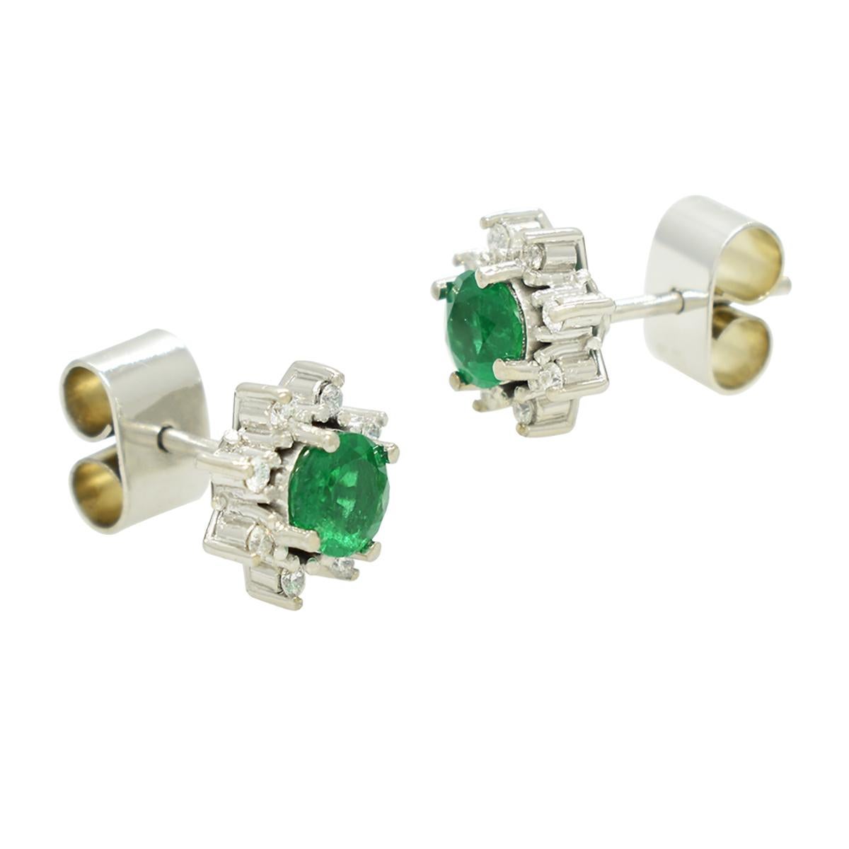 Emerald and diamond stud earrings with an exquisite selection of gemstones; 2 gorgeous round cut natural emeralds from Colombia with dark and vivid green color full of life in 0.73 carats total weight, and 16 round cut diamonds in 0.16 carats total