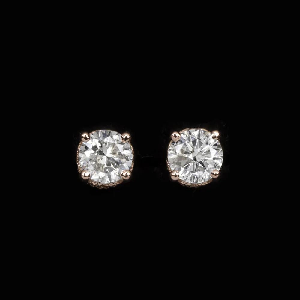 Beautiful diamond stud earrings that offer a super classic look. 
The rose gold filigree settings add a unique, vintage style touch, the diamonds weight in total 0.73 carat.
The Color of the diamonds is I J that appears quite white set in 14K Rose