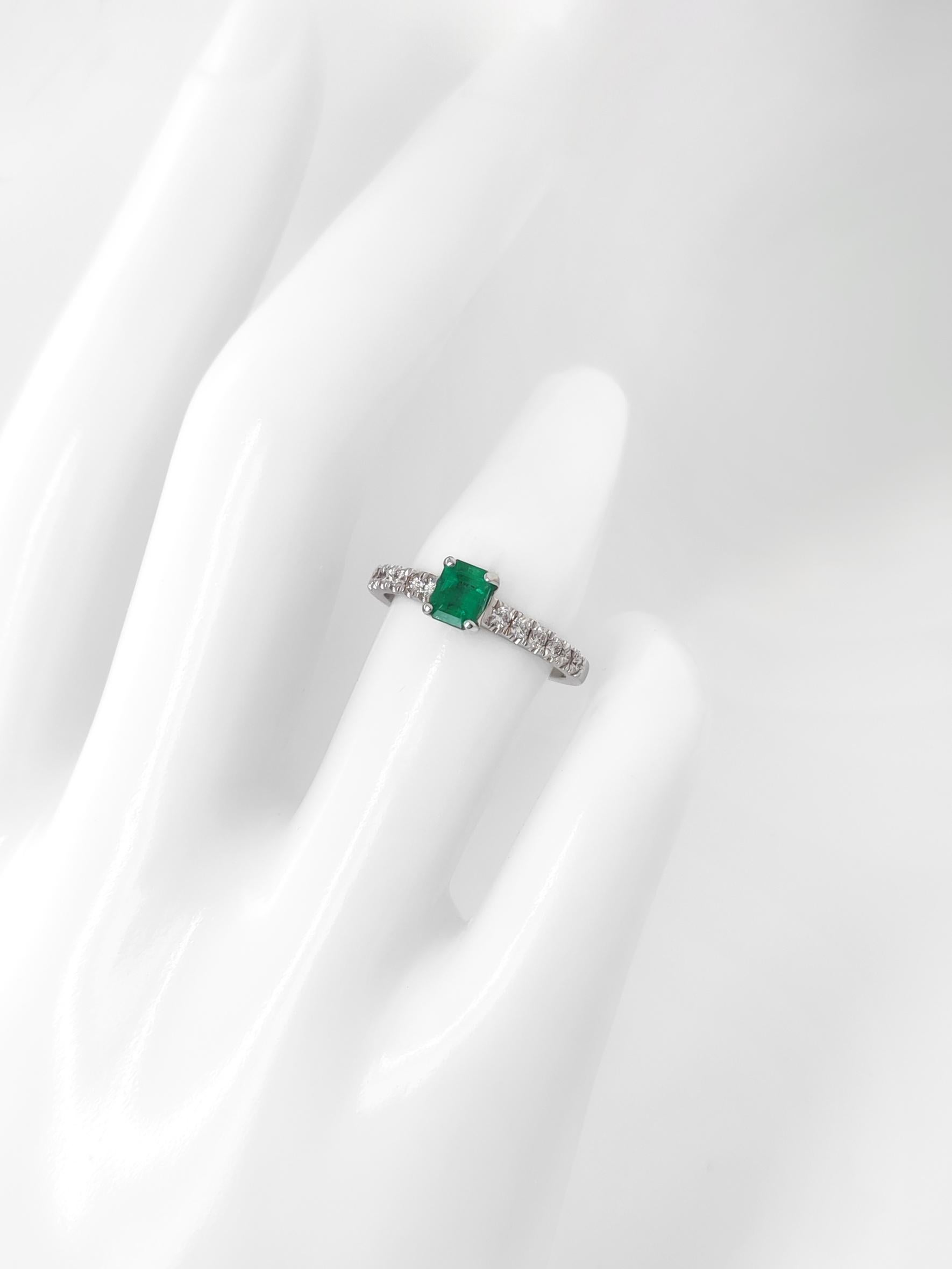FOR US BUYER NO VAT

This charming ring features a 0.43 carat green emerald as its focal point, displaying the enchanting green hue that emeralds are known for.

Enhancing the emerald's beauty are 12 diamonds, totaling 0.43 carats. These diamonds