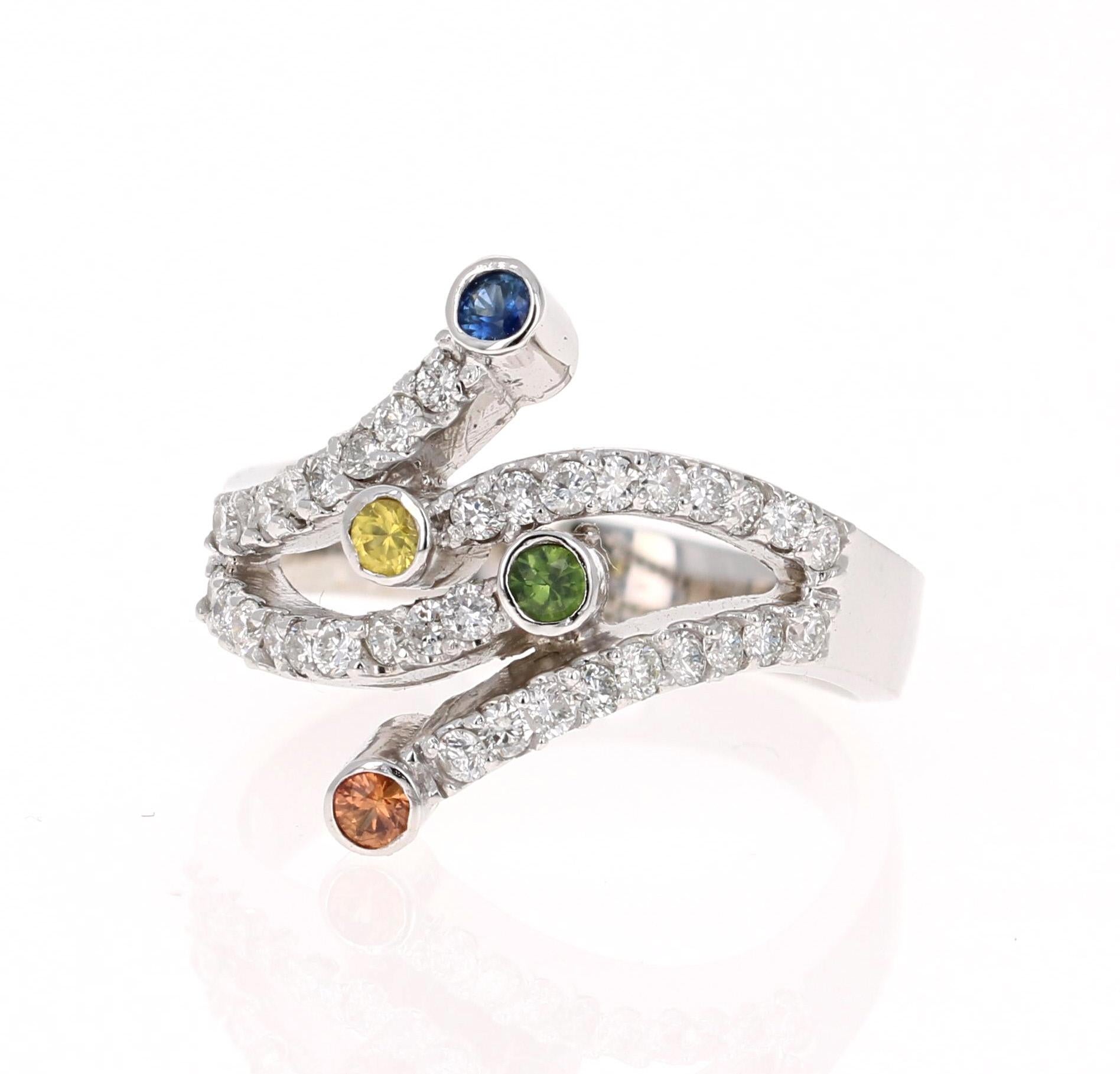 A Uniquely designed Multi-Colored Sapphire and Diamond Ring that is sure to be a great addition to your jewelry collection!  
This ring has 4 Round Cut Multi-Colored Sapphires that weigh 0.20 carats which are surrounded by 36 Round cut Diamonds that