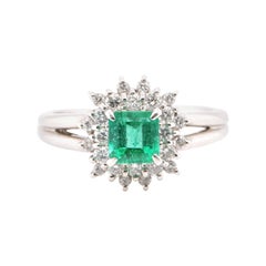 0.74 Carat Natural Emerald and Diamond Cluster Ring Set in Platinum