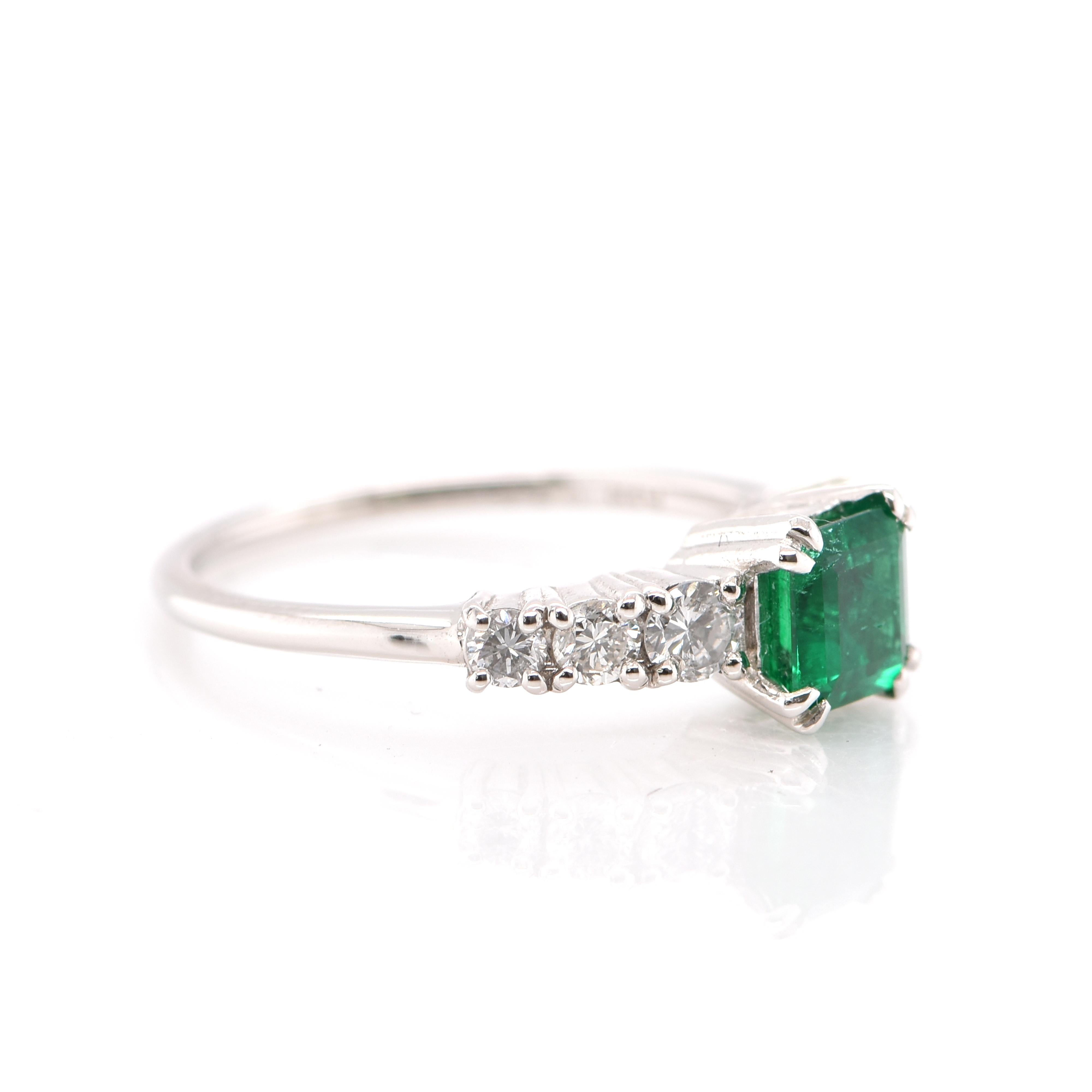 Modern 0.74 Carat Natural Emerald and Diamond Engagement Ring Set in Platinum For Sale