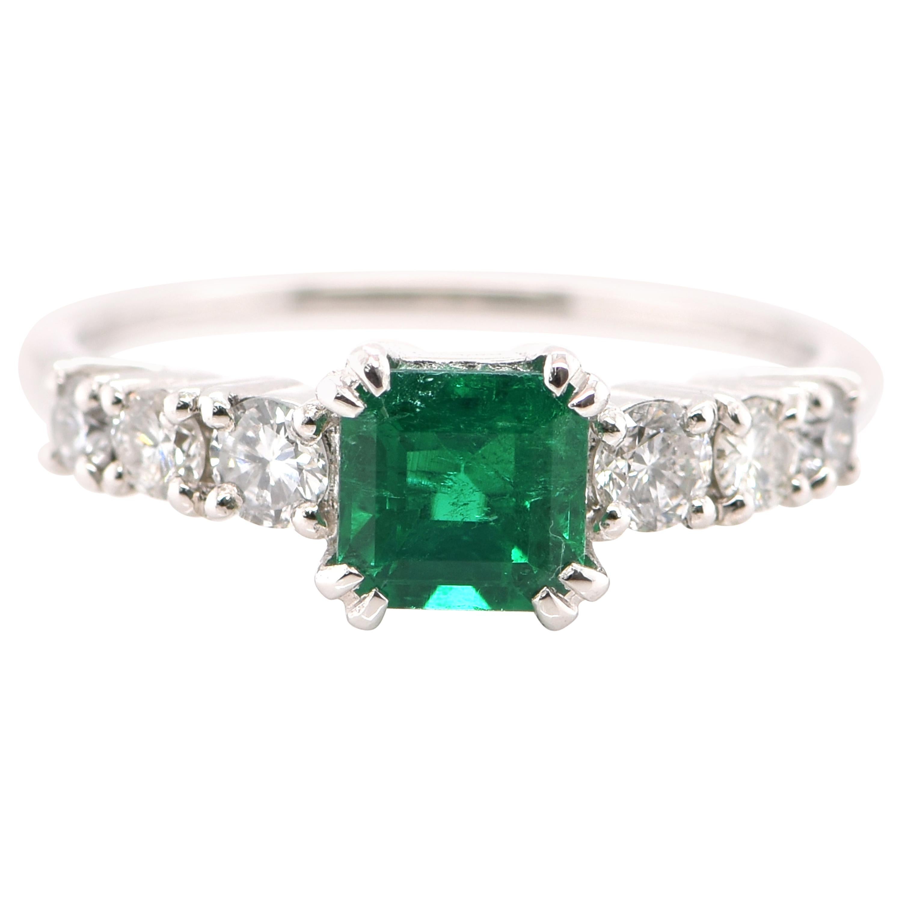0.74 Carat Natural Emerald and Diamond Engagement Ring Set in Platinum For Sale