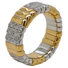 Bague souple en or jaune et blanc, sertie d'un diamant rond de 0,74 carat