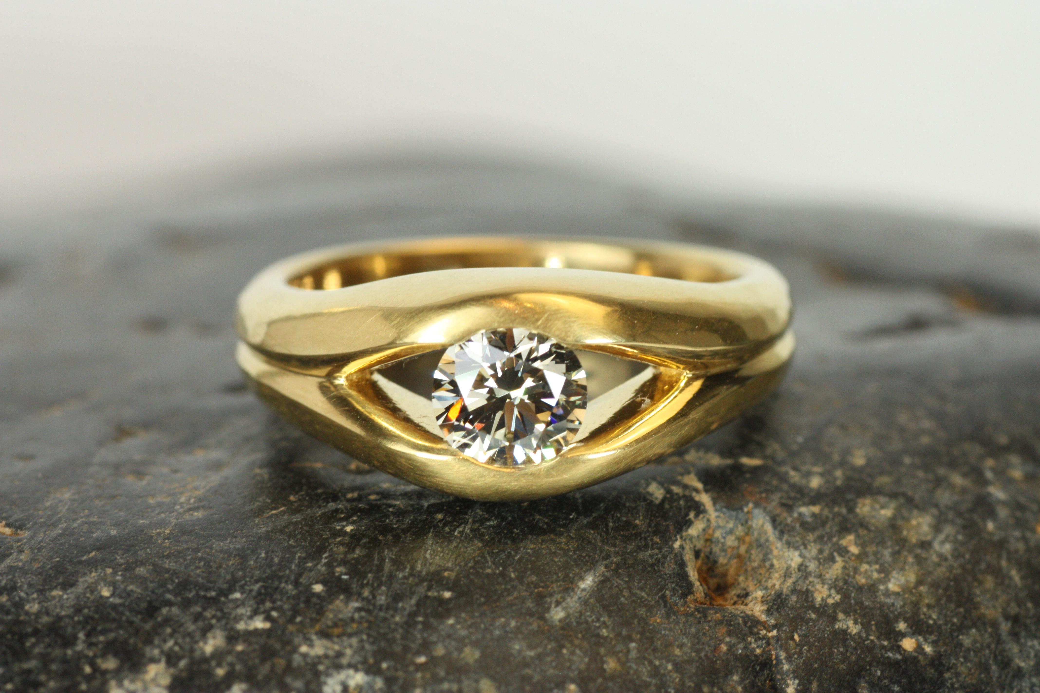 An exquisite symbol of love and commitment, this split-shank solitaire ring showcases a 0.74ct round natural diamond with a soft champagne hue. Its classic yet modern design in 22K yellow gold makes it an unforgettable choice. This show-stopping