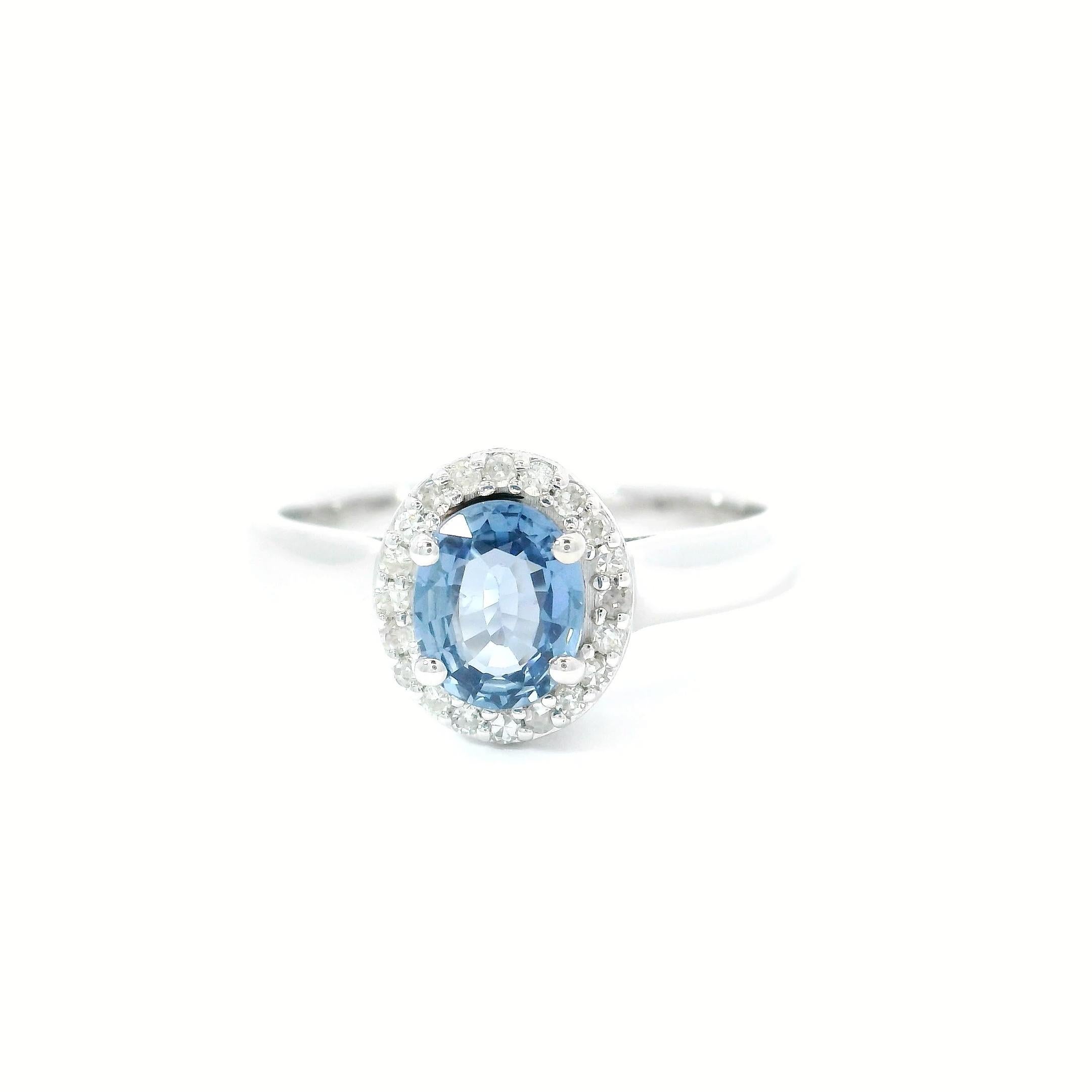 18kt white gold Sapphire Ring
  
  Gold colour & karat: White gold 18kt
  Weight: 3.93 grams
  
  Set with-
  Stone type: Diamond
  Shape: Ovel 
  Carat: 0.74 cts
  Colour: Blue Colour
  
  Surrounding Stones: Diamonds
 1) White Diamonds
  Carat