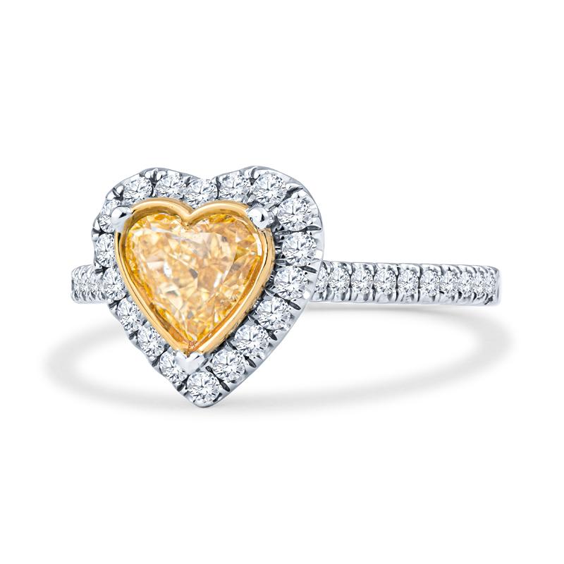 This engagement ring is an 18kt white and yellow gold heart-shaped engagement ring set with one bezel set 0.74ct heart shaped Fancy Intense Yellow, SI2 clarity GIA certified diamond in the center (5.89 x 6.40 x 2.83 mm) and 0.43 ctw of round