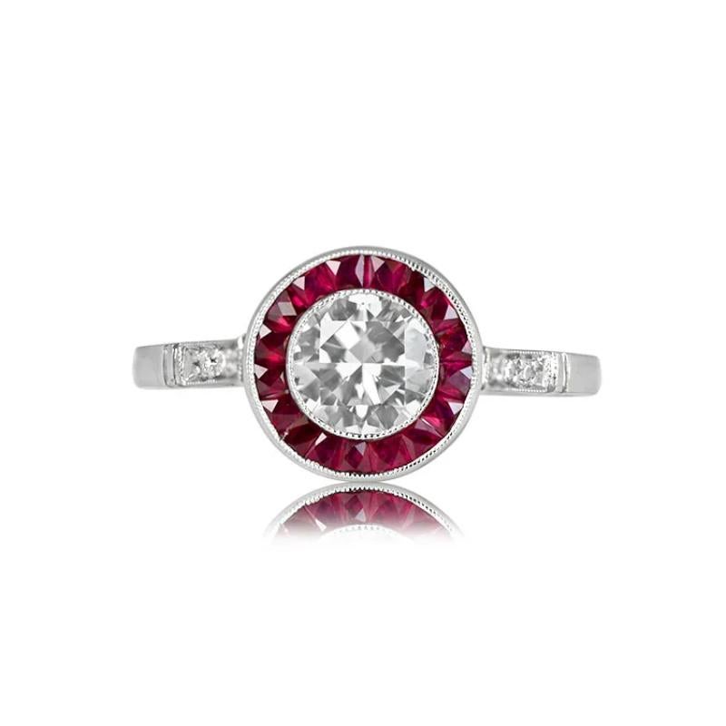 A captivating design featuring a vibrant round brilliant cut diamond, 0.74 carats, I color, VS2 clarity, embraced by a halo of French cut rubies. Diamond accents grace the shoulders, while milgrain detailing and openwork filigree enhance the