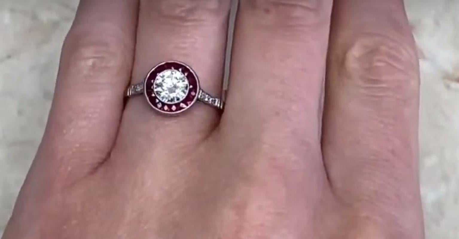 This exquisite handcrafted platinum ring showcases a breathtaking halo of meticulously arranged French-cut rubies, elegantly encircling a dazzling 0.74-carat round brilliant-cut diamond. Graded I in color and VS2 in clarity, the diamond radiates a