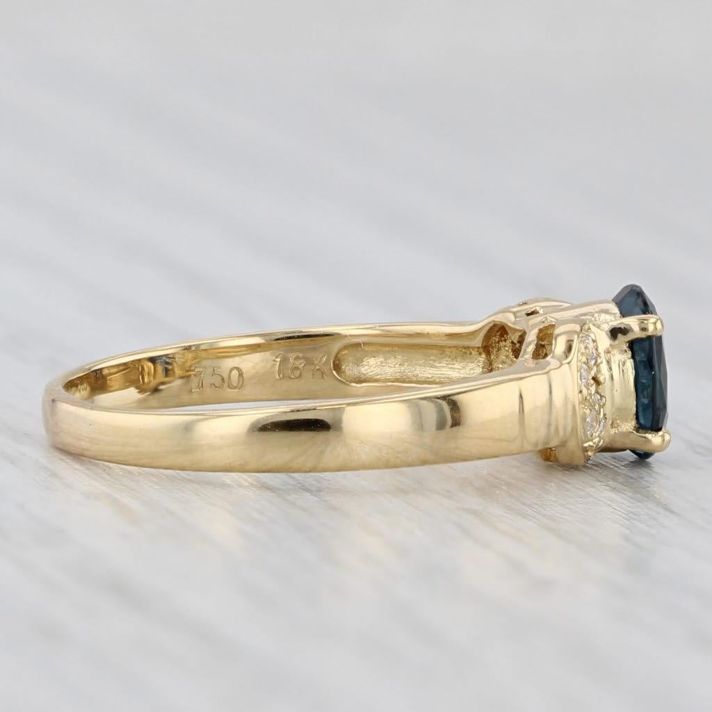Gemstone Information:
- Natural Sapphire -
Carats - 0.70ct 
Cut - Oval Brilliant
Color - Dark Blue
Treatment - Heated

- Natural Diamonds -
Total Carats - 0.04ctw
Cut - Round Brilliant
Color - F - G
Clarity - I1 - I2

Metal: 18k Yellow Gold
Weight: