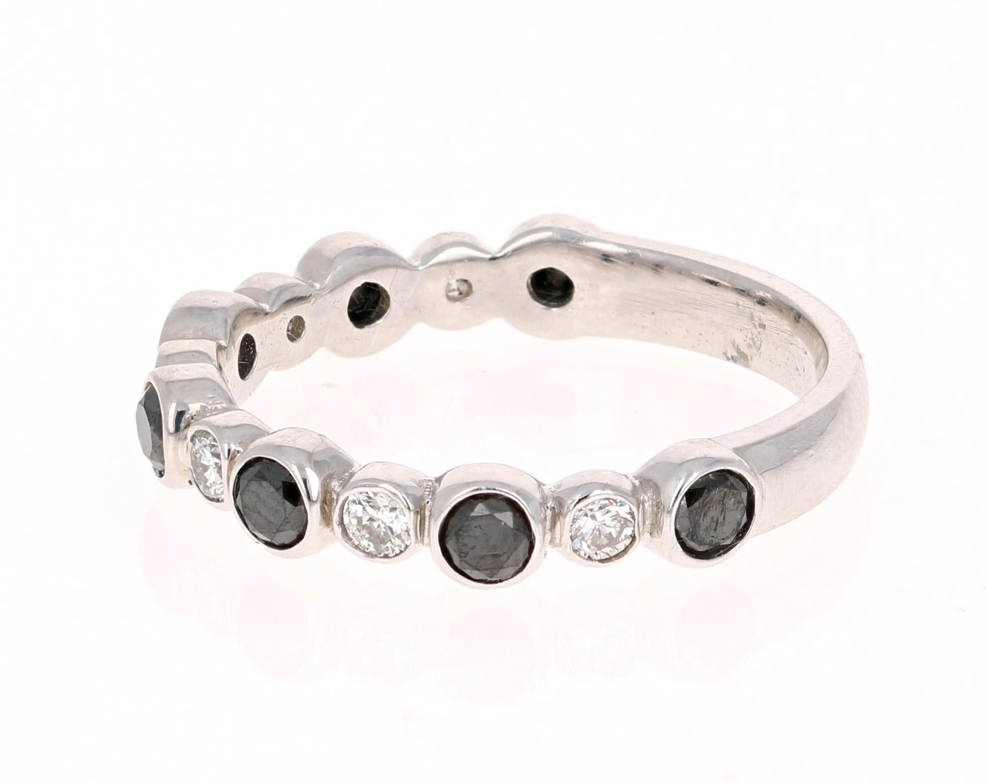 Cute and Dainty 0.75 Carat Black Diamond and White Diamond Band that is sure to be a great addition to anyone's accessory collection.   There are 7 Round Cut Black Diamonds that weigh 0.54 carats and 6 Round Cut Diamonds that weigh 0.21 carats.  The