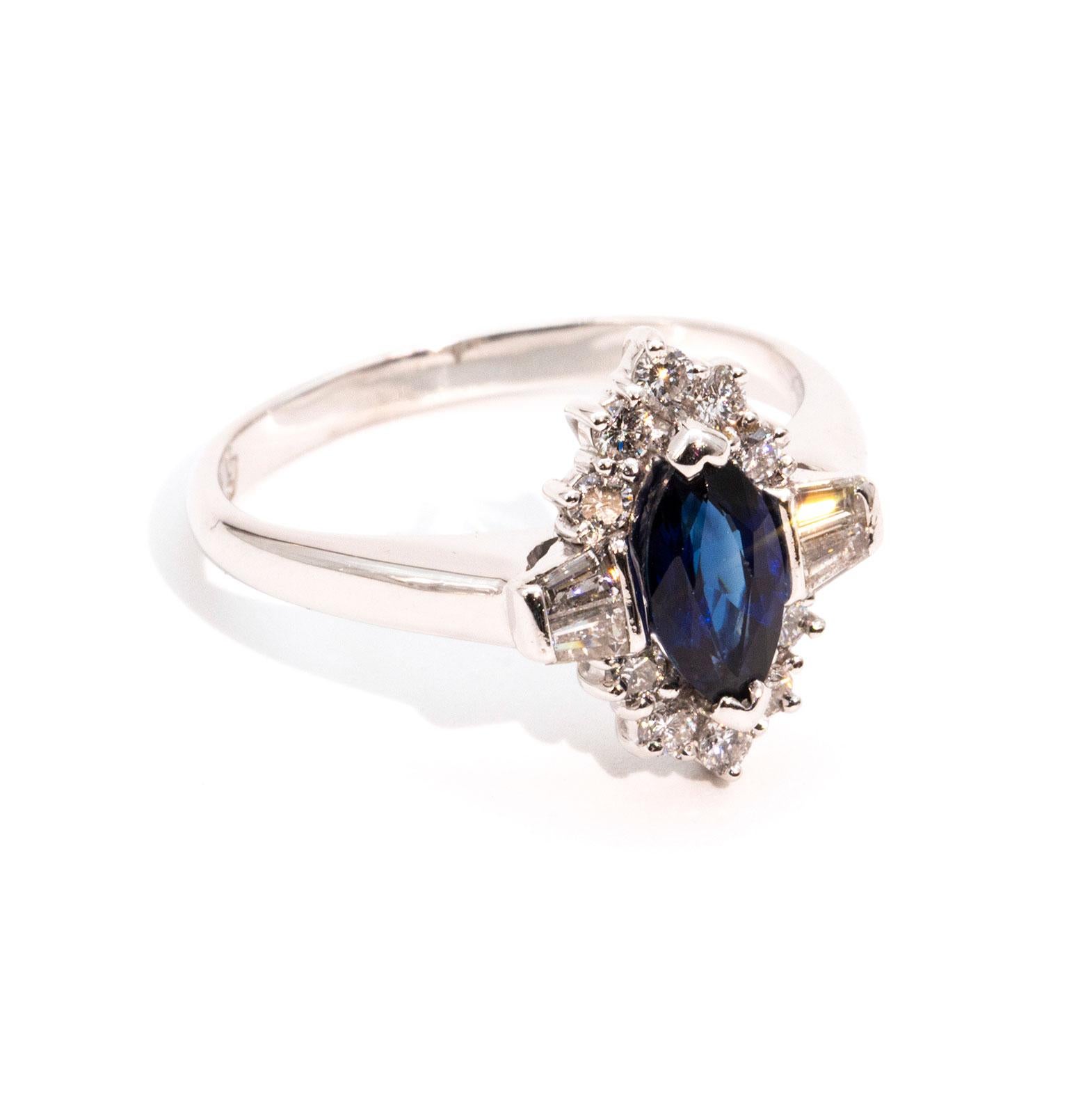 This carefully handmade, art deco inspired, uniquely original ring is forged in 18ct white gold and features a beautiful natural Australian blue marquise 0.75 carat sapphire that is flanked by four beautiful tapered diamonds and is surrounded by ten