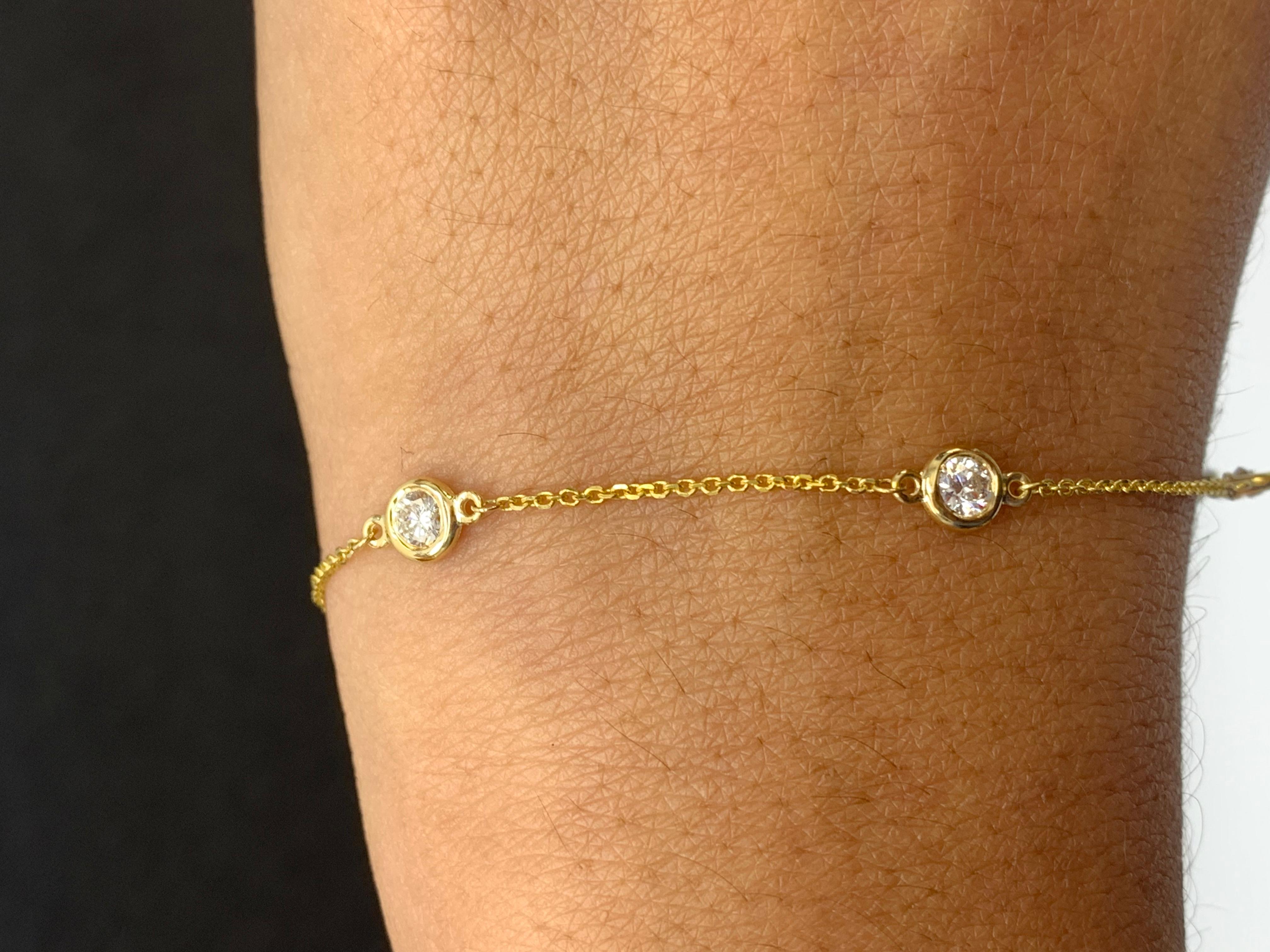 A modern 7-inch Diamond by the Yard bracelet showcasing five round diamond bezel set in 14 karats yellow gold. Diamonds weigh 0.75 carats in total.

Style available in different price ranges. Prices are based on your selection of the 4C’s (Carat,