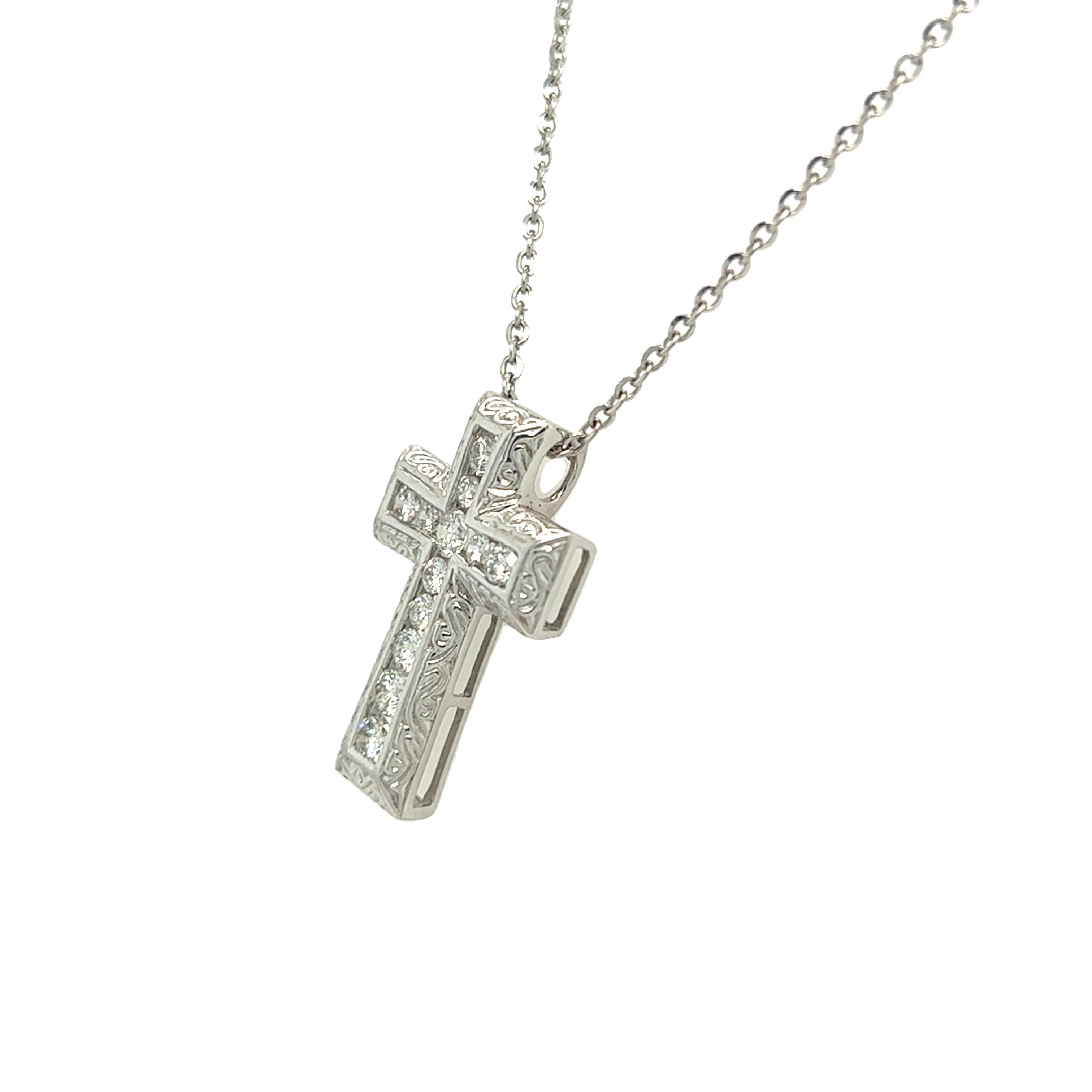 From our estate collection, this beautiful diamond cross pendant is made of 14K white gold. The diamonds in the center row are set in a channel for a smooth and clean look. It has a substantial presence and features 0.69 carat of diamonds in an