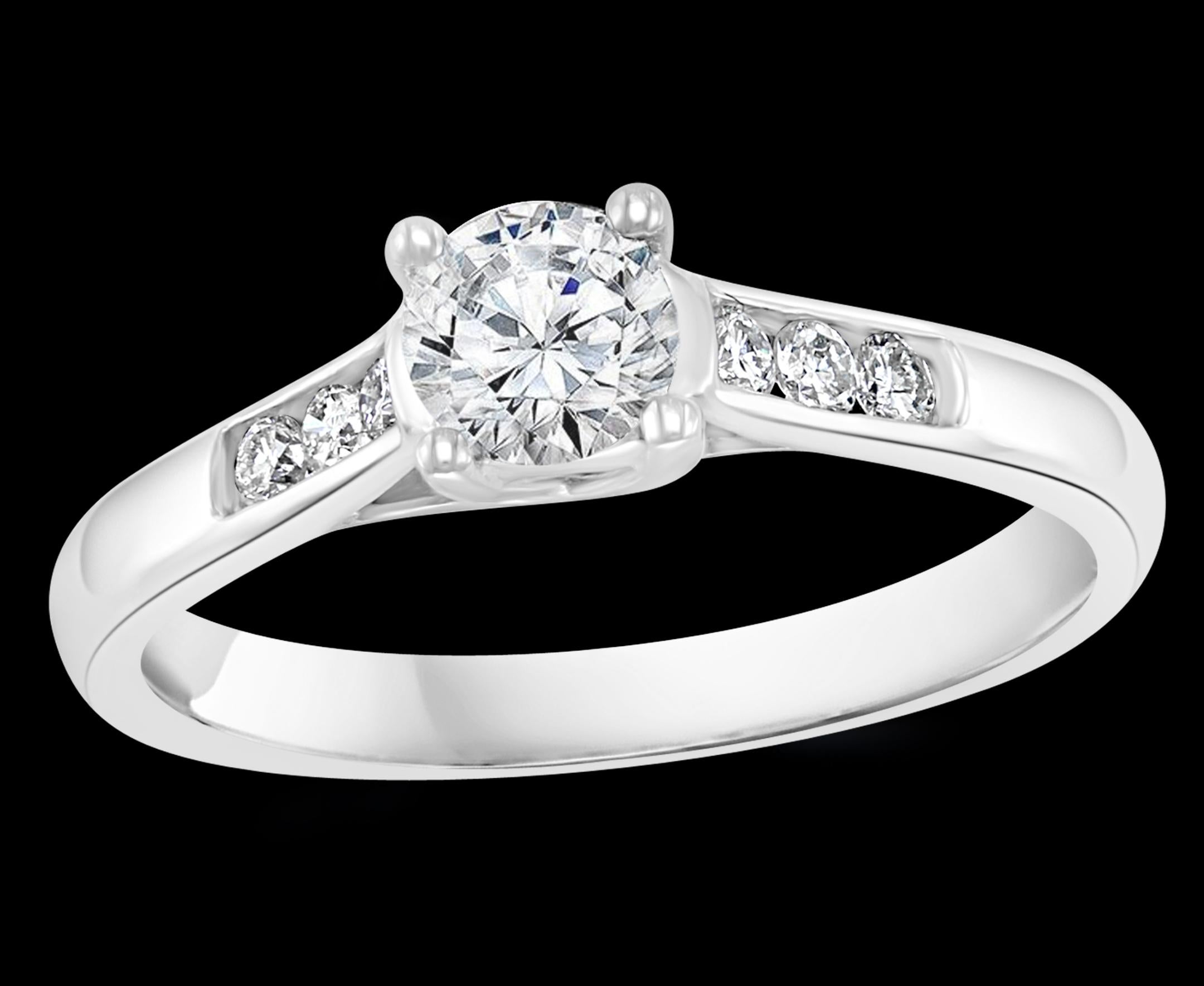 0.75 Carat Diamond  Traditional Ring/Band 14 Karat White Gold

Brilliant cut solitaire round diamond approximately 0,6 ct and 6 brilliant cut diamond, three on each side   next to each other .
Center stone is approximately 60 pointer while the side