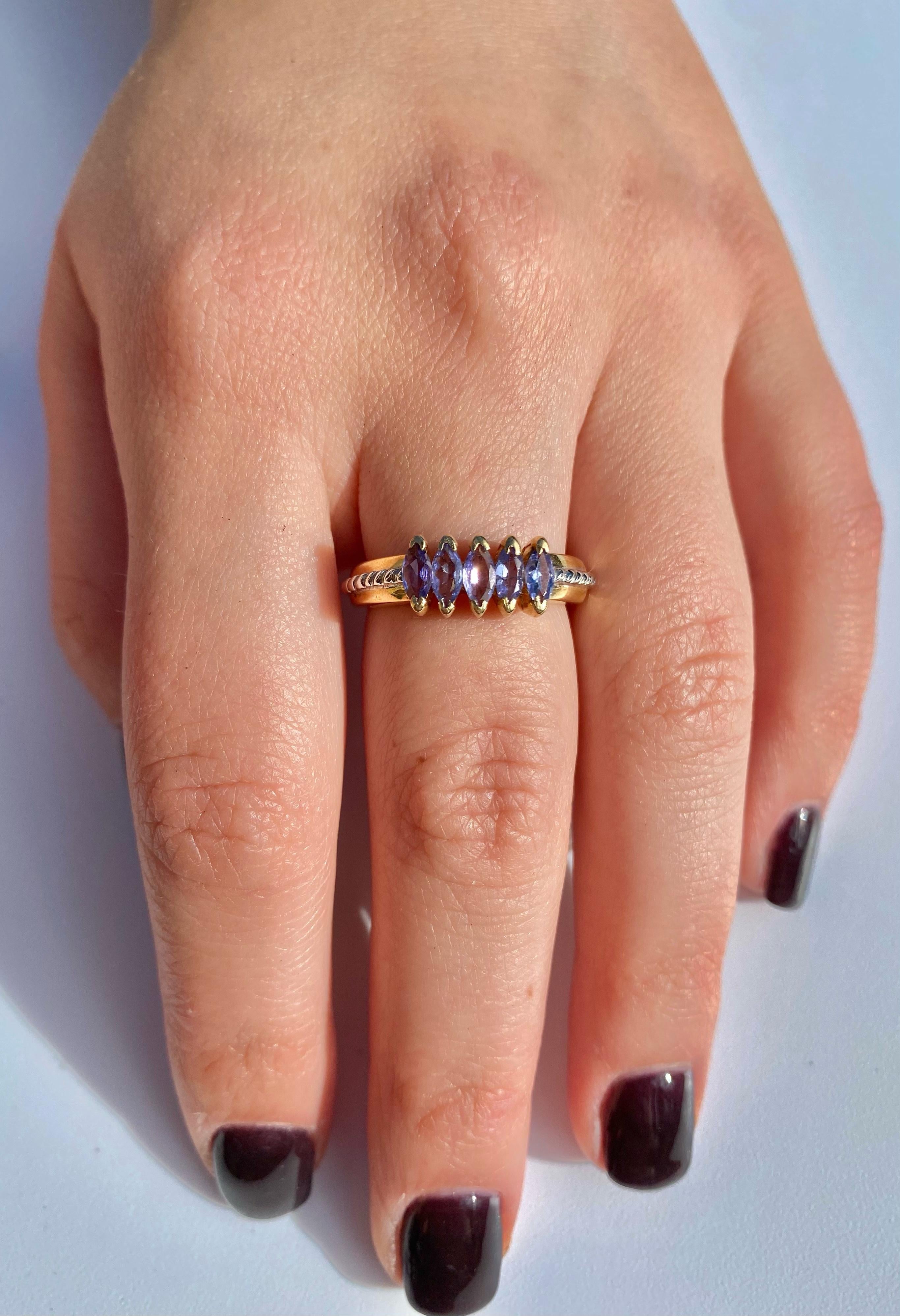 Centering Five Marquis-Cut Tanzanites totaling 0.75 Carats and set in 14K Yellow Gold, this multi-colored ring is ideal for stacking with other gemstones, such as White Diamonds or Emeralds. 

Details:
✔ Stone: Tanzanite
✔ Center-Stone Weight: 0.75