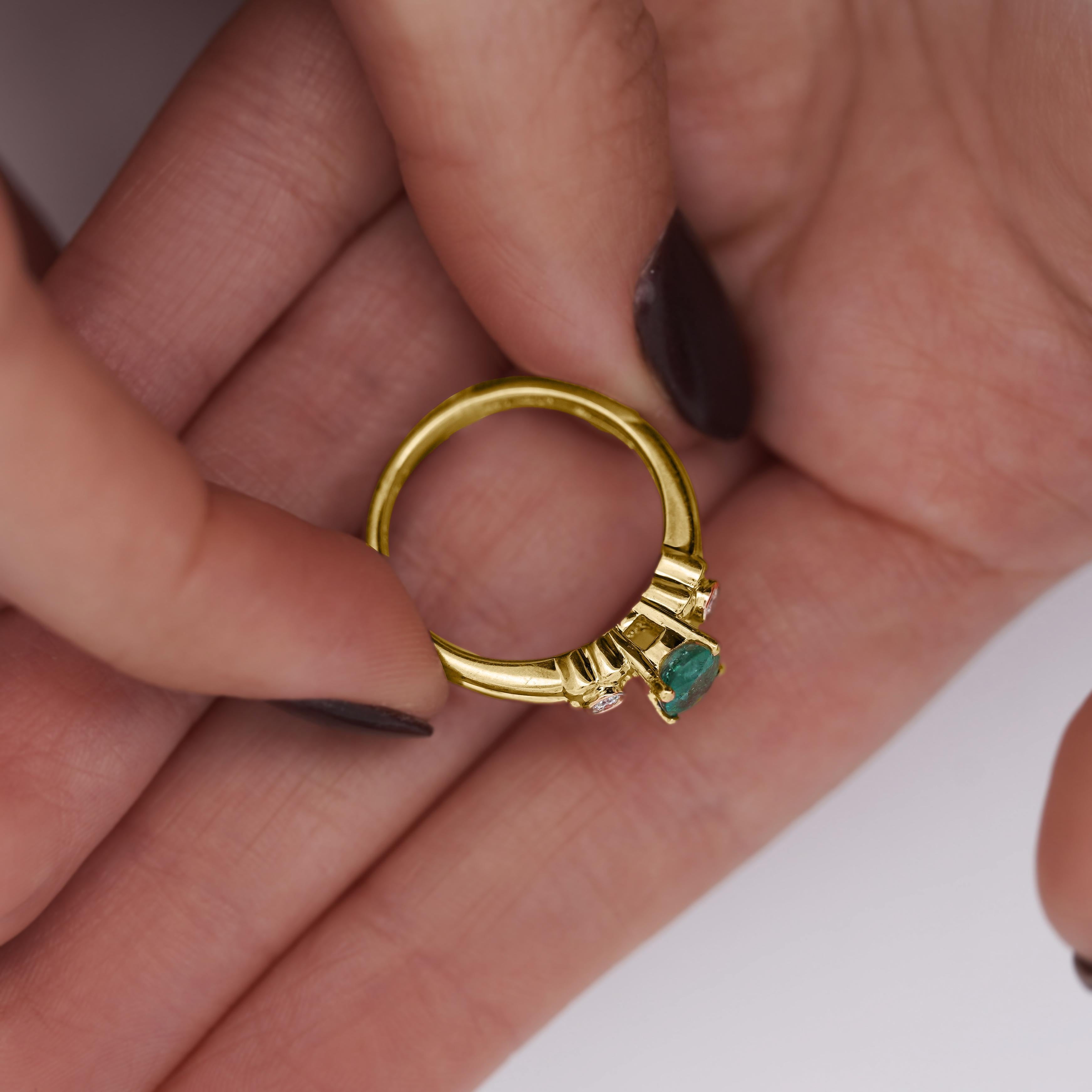A dainty emerald statement ring featuring a 0.75 carat natural emerald, accented by two delicate diamond side stones, set in warm 14K yellow gold.

Details:
Item Type: Statement Ring
Metal: 14K Yellow Gold
Size: 7 3/4
Weight: 3.23 grams

Center