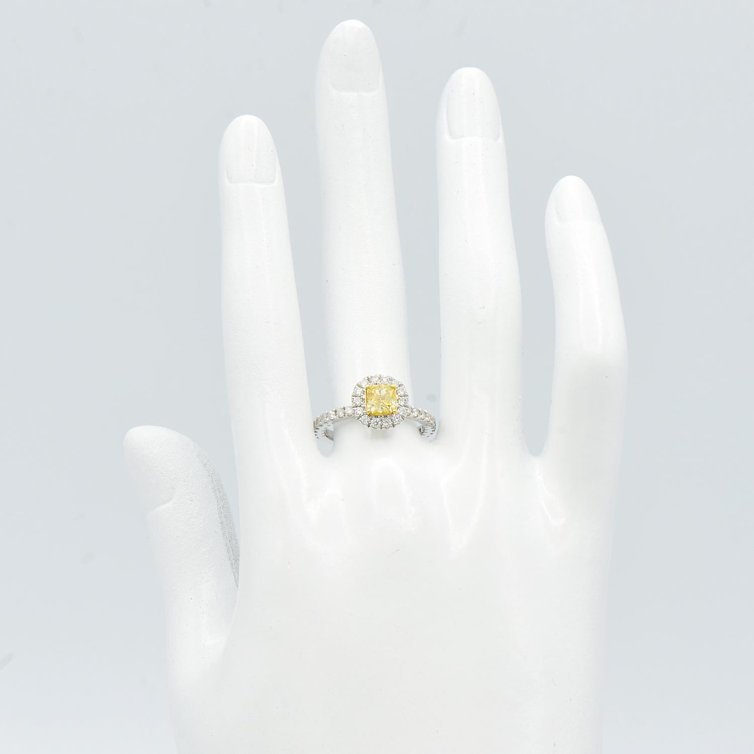 Contemporary 0.75 Carat Radiant Cut Yellow Diamond Ring with Diamond Halo and Band For Sale