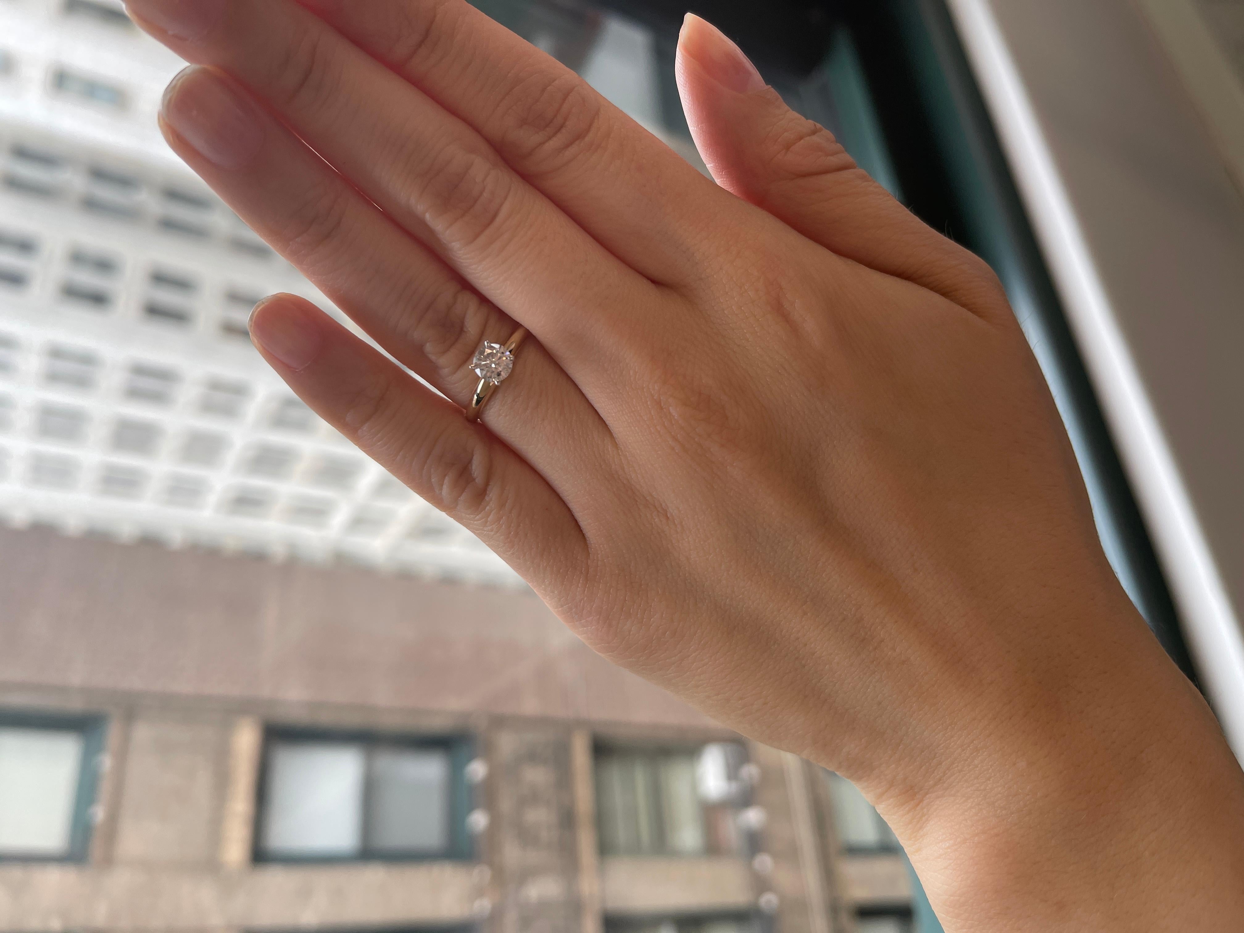0.75 carat diamond ring on finger