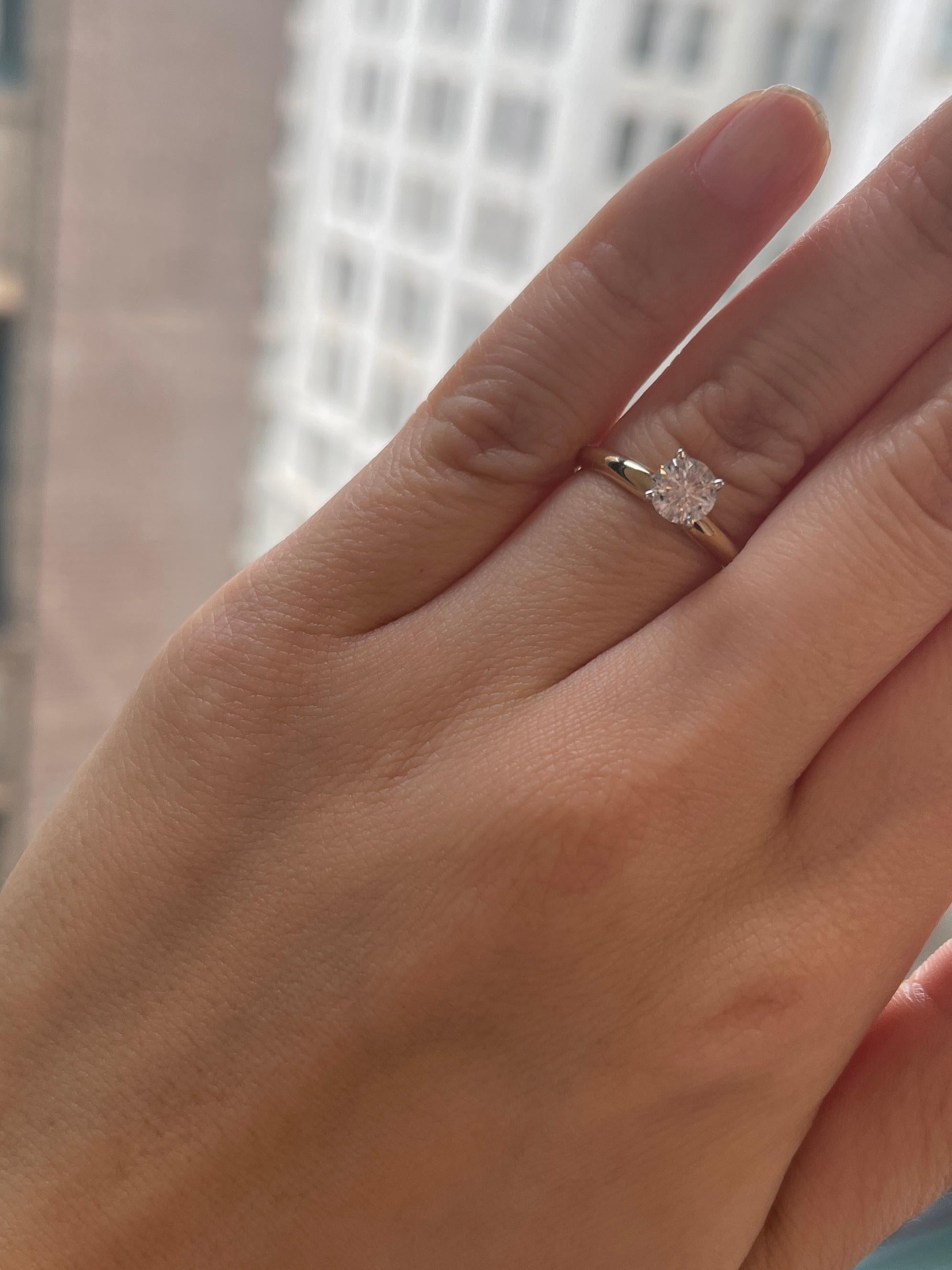 0.75 carat diamond ring on finger