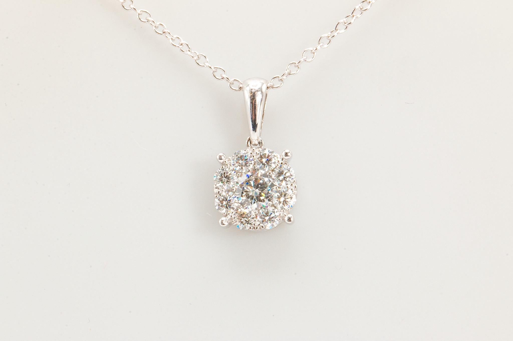 A contemporary halo-style setting, this 14K white gold cluster pendant is thoughtfully designed so that all 9 stones are set with their tables flush, giving the illusion of one much larger stone.

The diamonds weigh 0.75ct altogether and range from