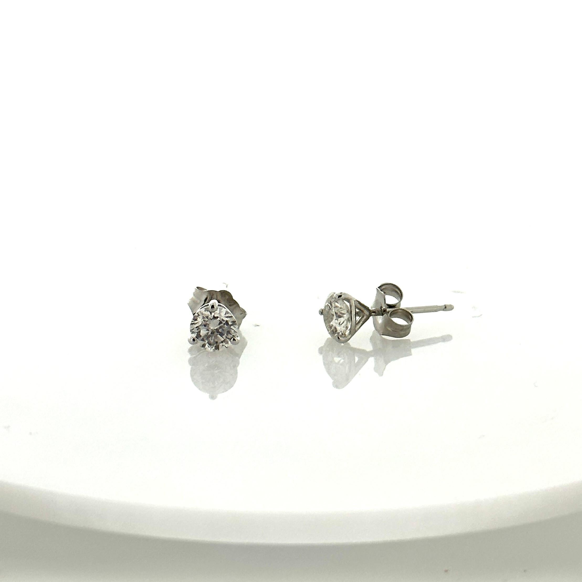 Stunning 14 Karat white gold handmade earrings featuring 2 round brilliant cut diamonds weighing 0.75 carat total I-J color and SI1 clarity. These gorgeous earrings are classic and timelessly elegant.