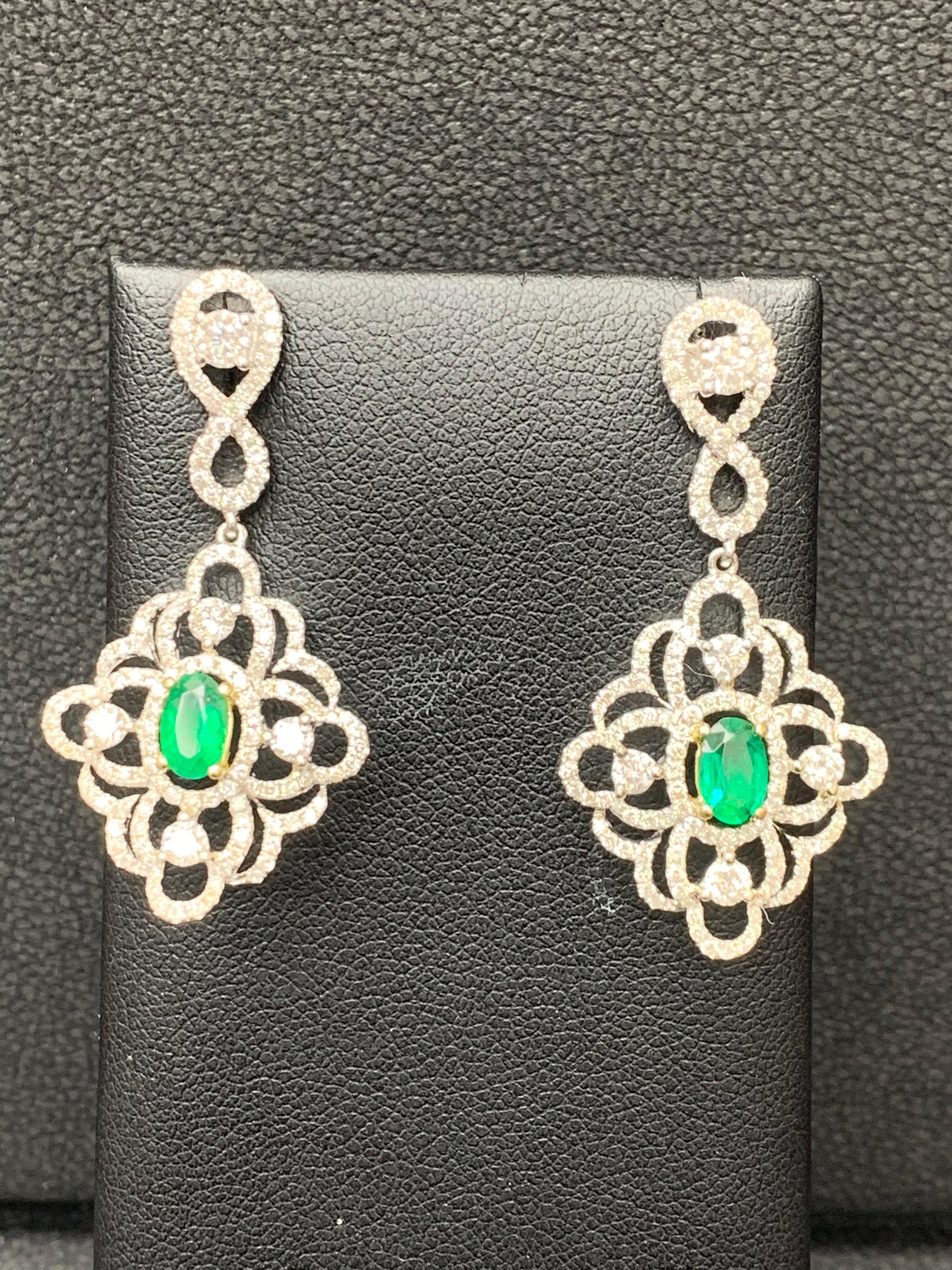 Women's 0.75 Oval Cut Emerald and Open-Work Diamond Chandelier Earrings in 18K Mix Gold For Sale