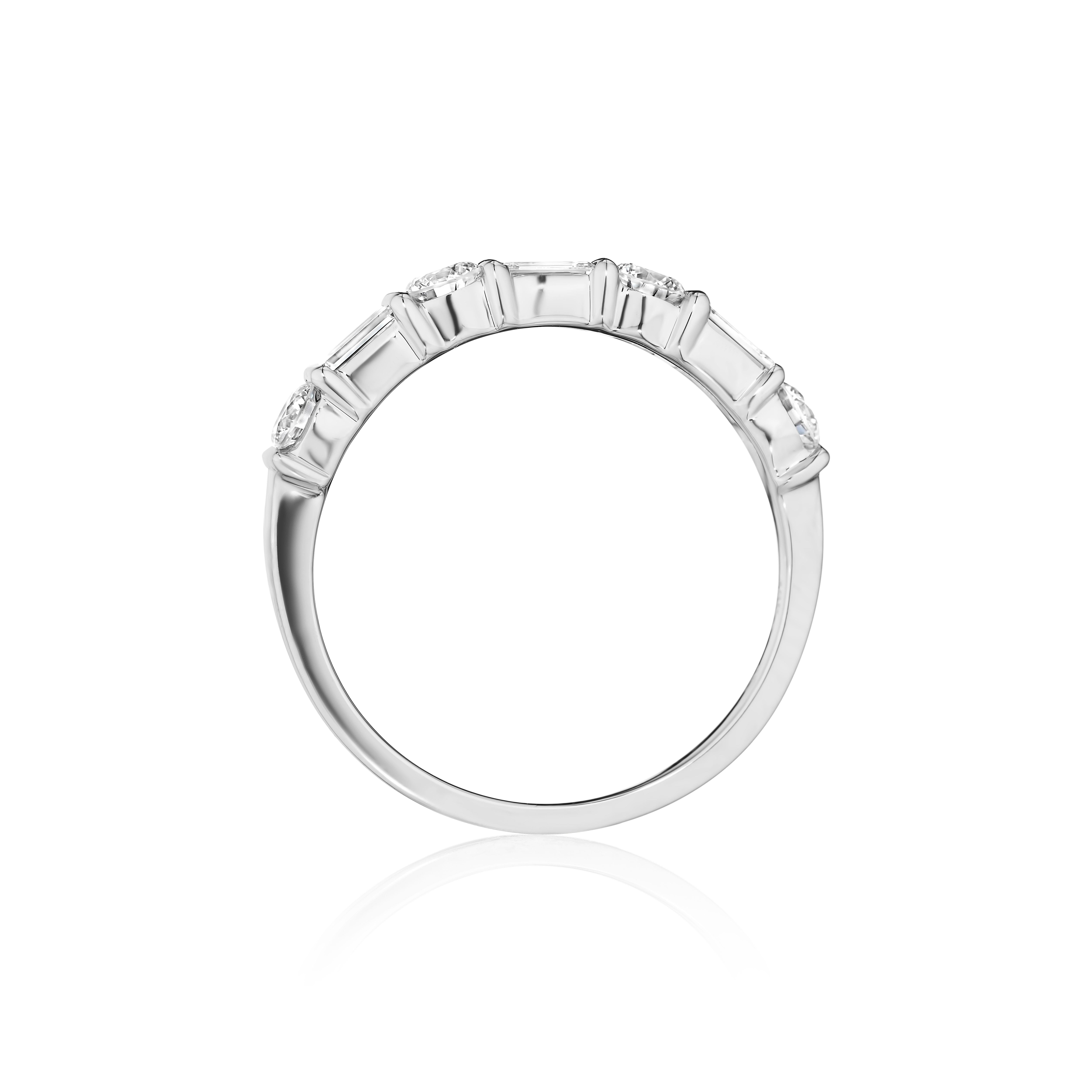 • Crafted in 18KT gold, this band is made with 7 alternating baguette and round cut diamonds, and has a combining total weight of approximately 0.75 carats. The diamonds are set into a bar setting. Worn beautifully on its own or stacked. A beautiful