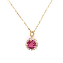 0.75ct Pink Sapphire Pendant Surrounded by 14 Round Diamonds Set in 14ct Gold
