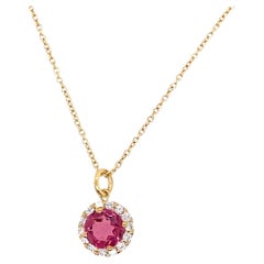 0.75ct Pink Sapphire Pendant Surrounded by 14 Round Diamonds Set in 14ct Gold
