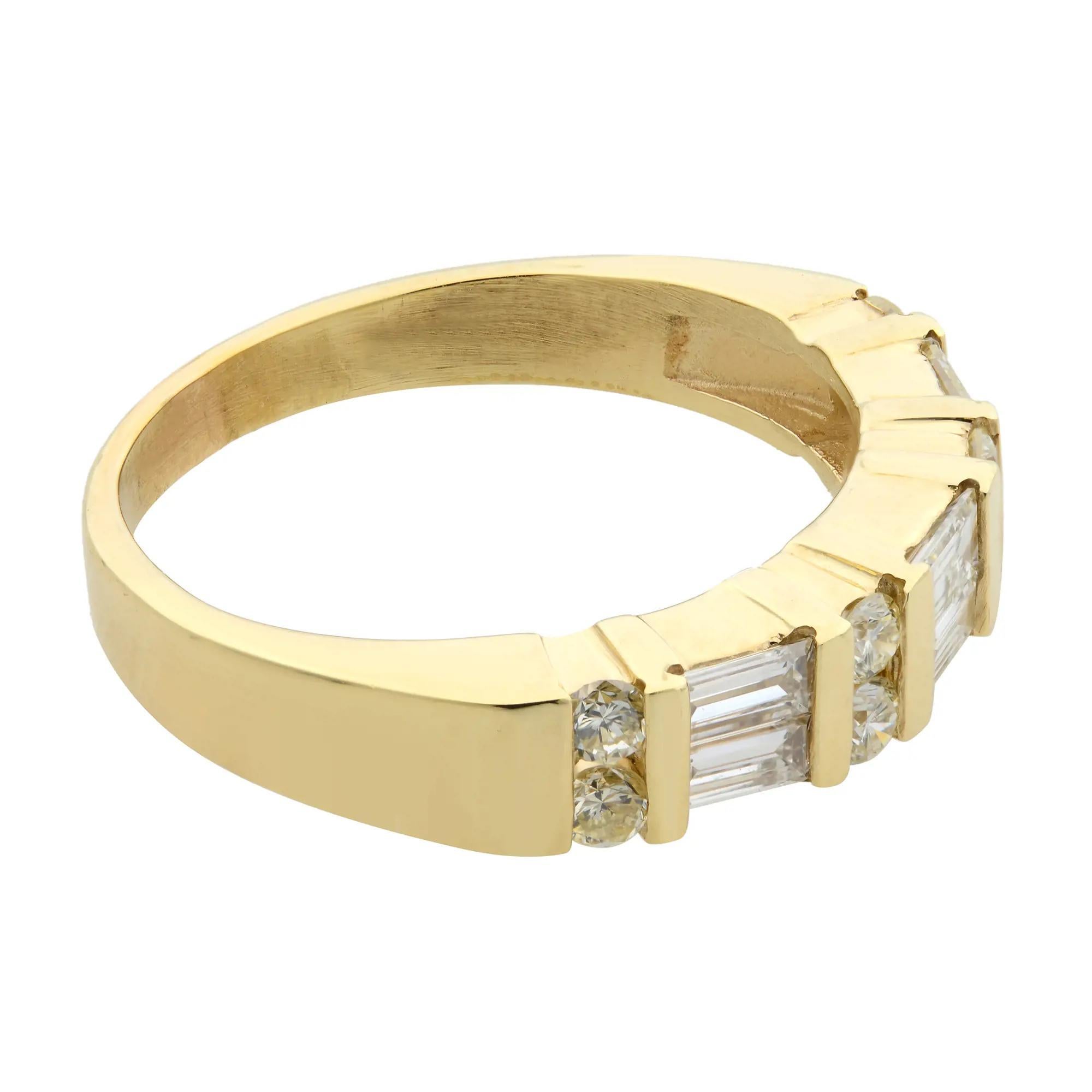 This beautiful band ring features shimmering baguette cut and round cut diamonds in channel setting that glimmers as it bends around the finger. Crafted in high polished 14k yellow gold. Diamond color G-H and VS-SI clarity. Total diamond weight: