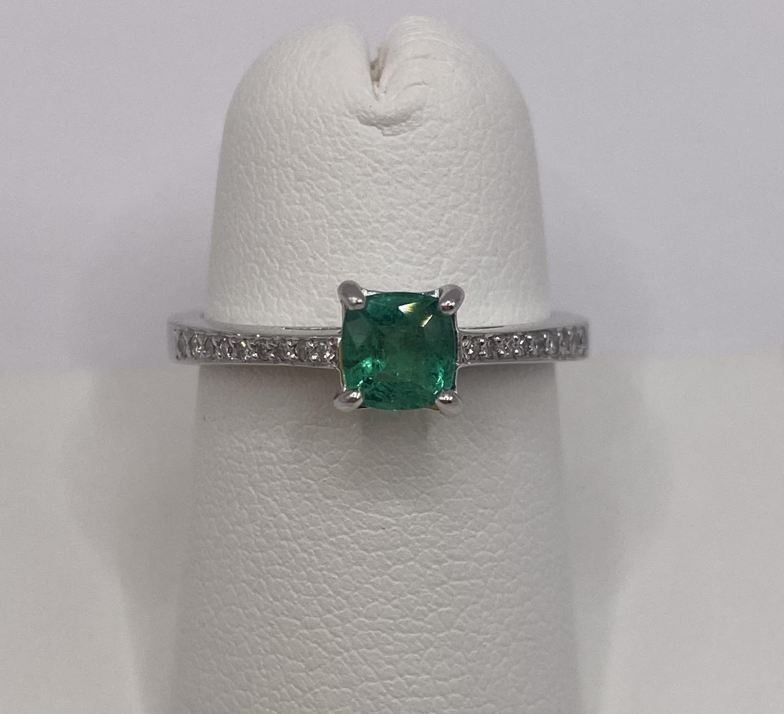Metal: 14KT White Gold
Finger Size: 6.50
Carat Total Weight: 0.75ctw
(Ring is size 6.5, but is sizable upon request)

Number of Cushion Cut Emeralds: 1
Carat Weight: 0.68ctw
Stone Size: 5.0 x 4.85mm

Number of Round Diamonds: 18
Carat Weight: 0.07ctw