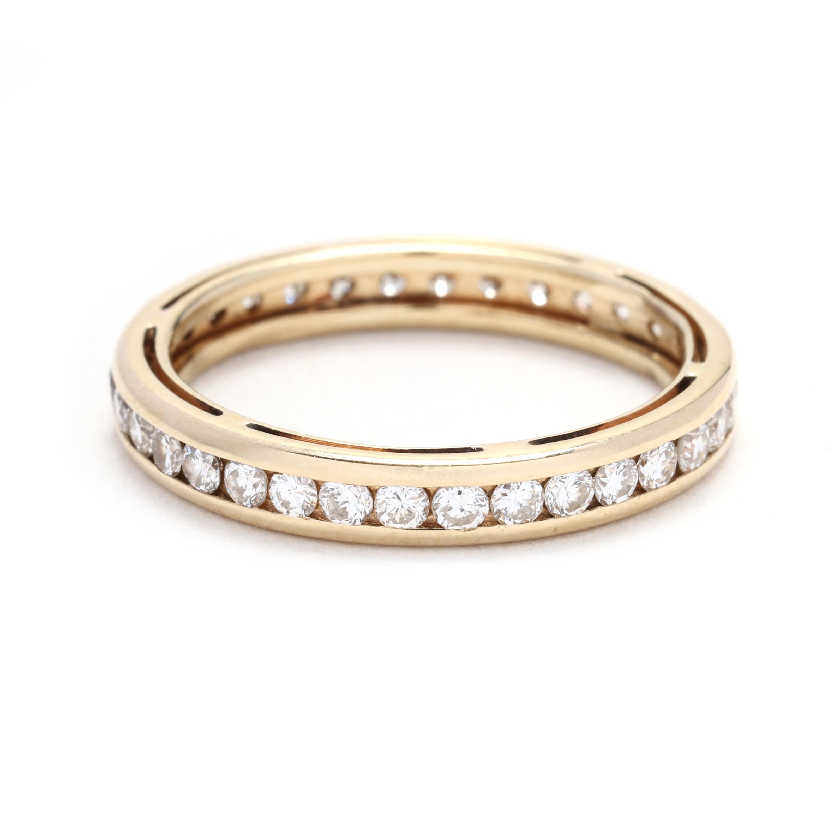 With a total carat weight of 0.75, this diamond and gold band ring is a truly mesmerizing piece. Crafted in 14k yellow gold, this ring features a row of sparkling diamonds that encircle the entire band. The diamonds are of high quality and emit a