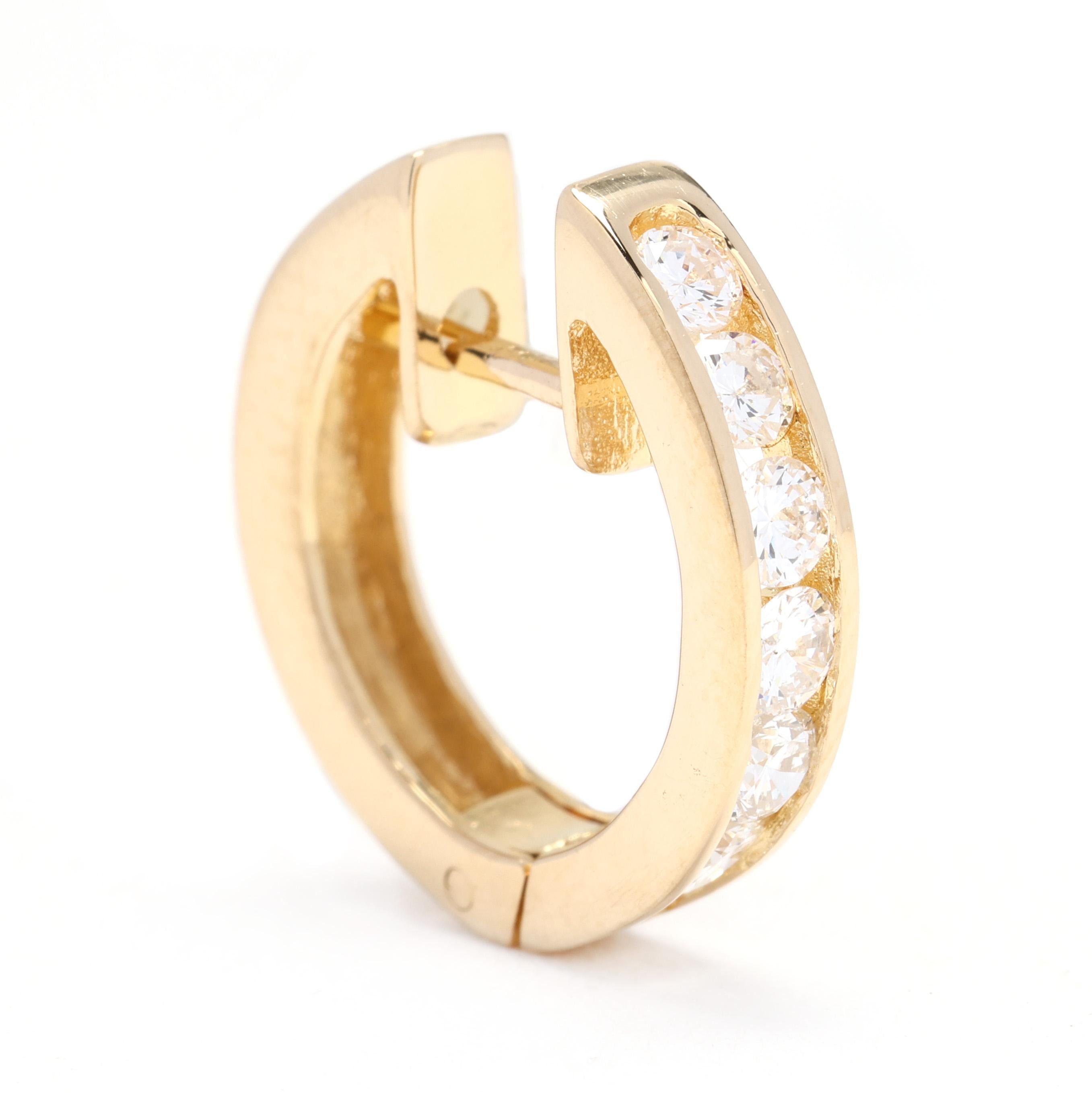 These beautiful 18k yellow gold hoop earrings are adorned with a total carat weight of 0.75 diamonds. The diamonds are expertly prong-set along the front of the hoops, creating a stunning display of sparkle and brilliance. With a huggie style, these