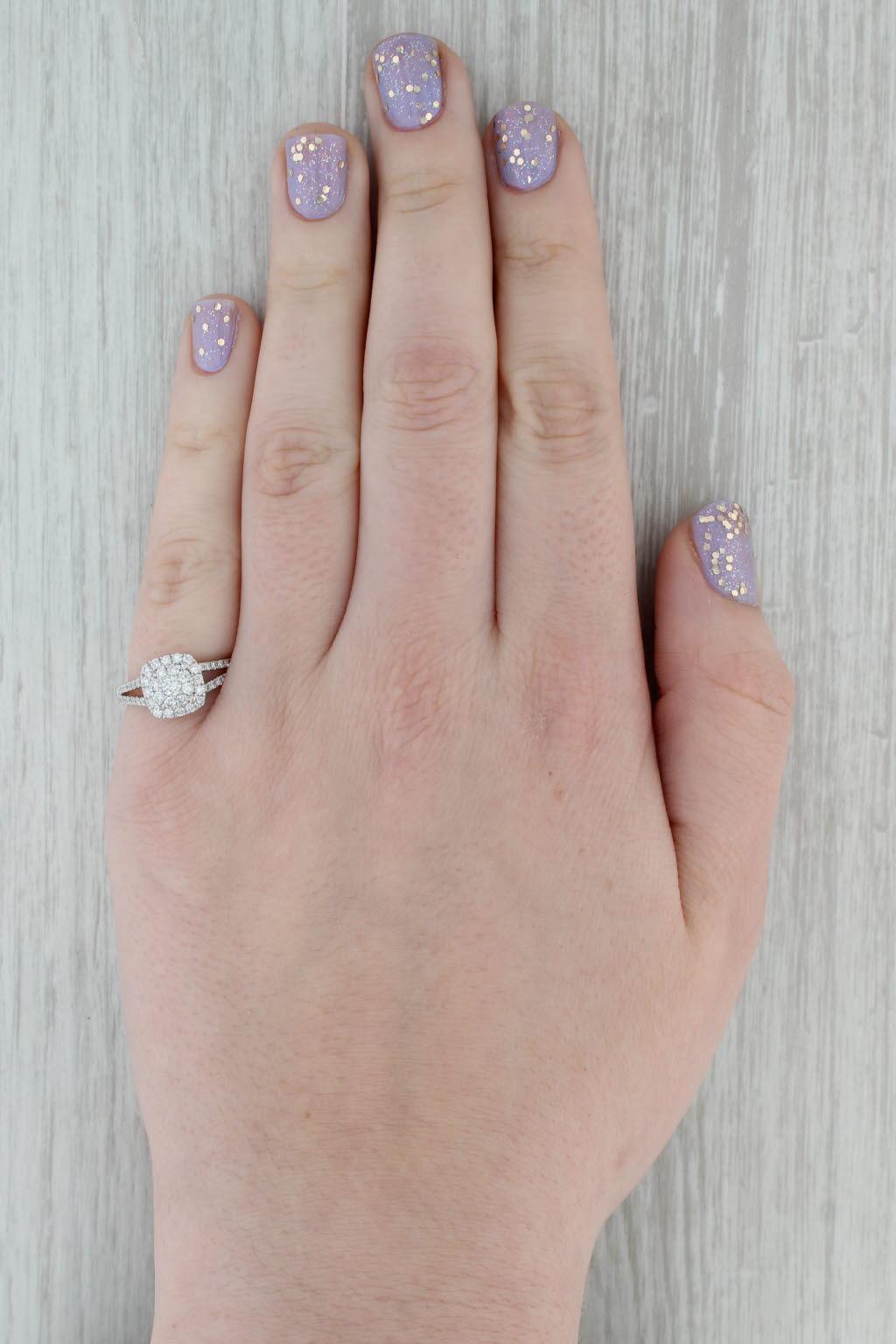 Gemstone Information:
- Natural Diamond (center) -
Carats - 0.10ct
Cut - Round Brilliant
Color - H - I
Clarity - SI1 

- Natural Diamonds (halo) -
Total Carats - 0.40ctw
Cut - Round Brilliant
Color - G - H
Clarity - VS2 - SI2

- Natural Diamonds