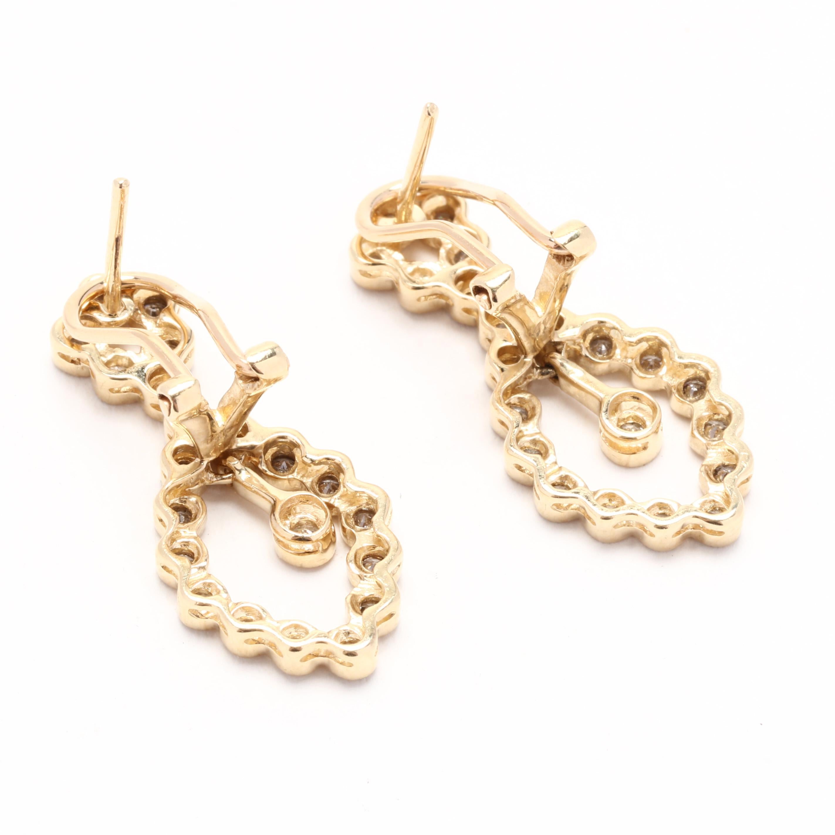 Verleihen Sie Ihrem Look einen Hauch von Eleganz mit diesen diamantenen Ohrringen mit einem Gewicht von 0,75 ct, die an einem Ohrring baumeln. Die aus 14 Karat Gelbgold gefertigten Ohrringe sind mit einer atemberaubenden Ansammlung von Diamanten