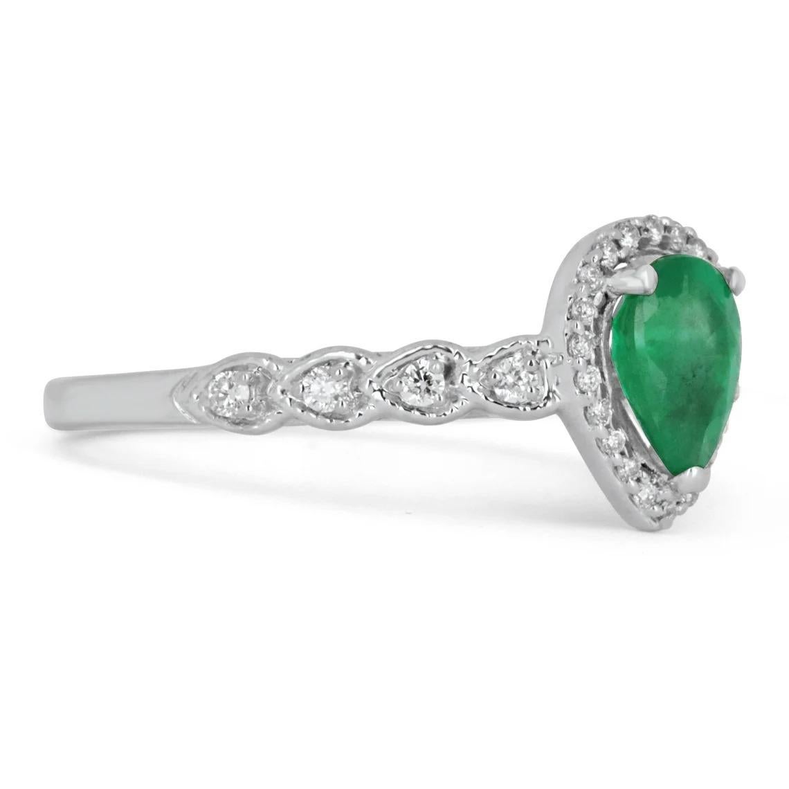 Elegantly displayed is a natural Colombian emerald and diamond halo engagement ring. The center gem is a fine quality pear-shaped emerald filled with life and brilliance! Among the emeralds, impressive qualities are its vibrant color and beautiful